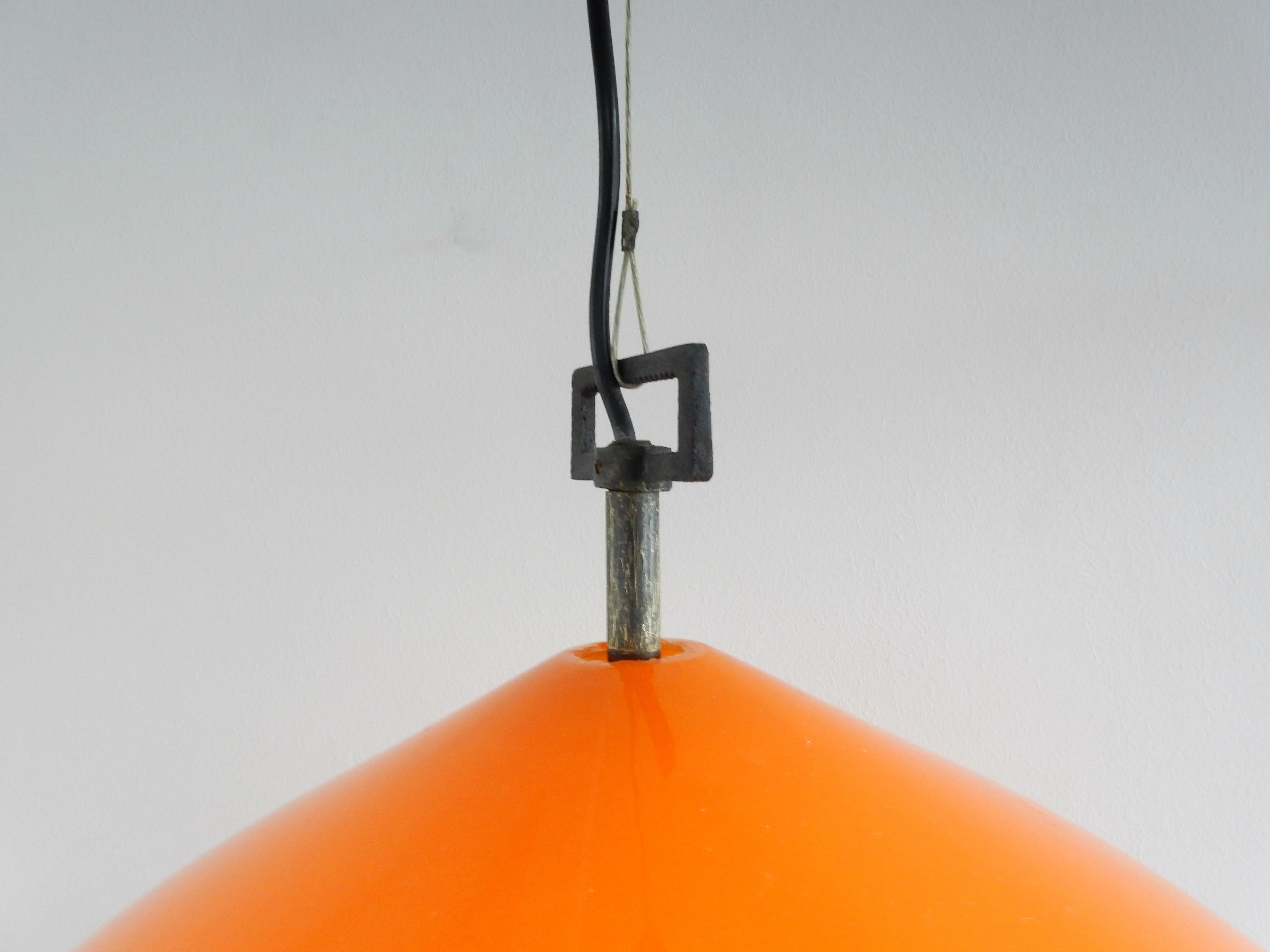 This very beautiful pendant lamp, model 'Onion', was designed by Alessandro Pianon for Vistosi in Italy. It has an orange Murano hand blown glass globe (onion). The inside has opaline white glass that gives a beautiful warm and pleasant light. The