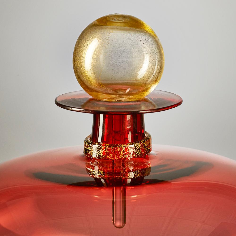 The modernist hand blown squat orb jewel bottle by Vetro Vero features peachy orange 