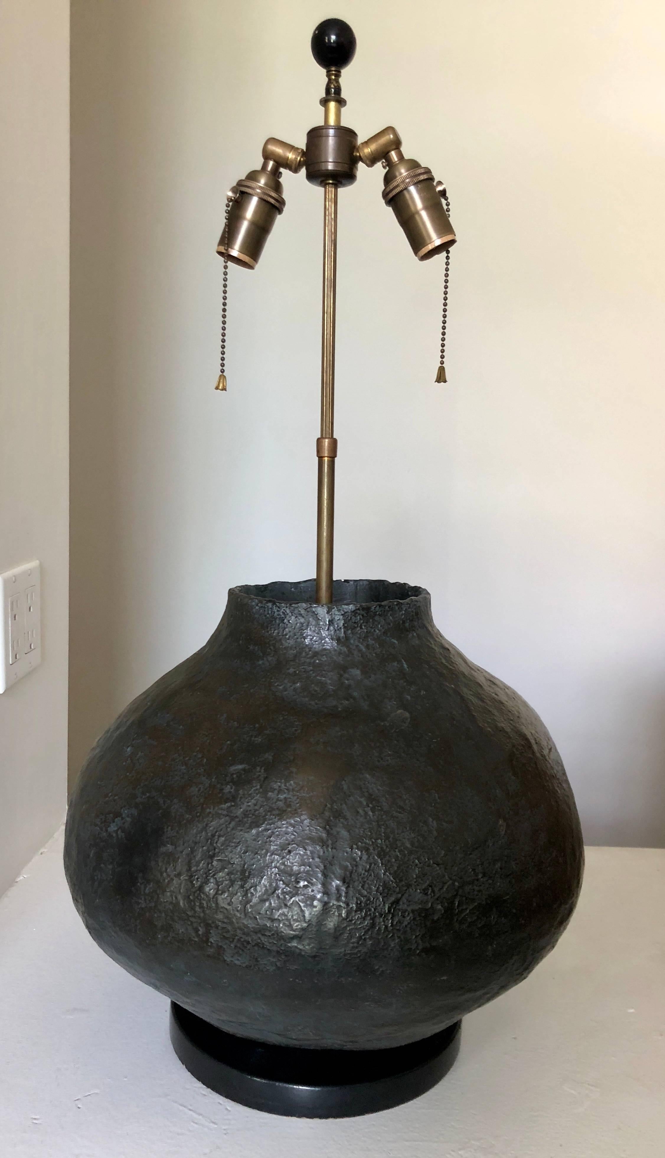 Interesting midcentury hand-thrown pottery lamp with textured surface and dark semi-mat glaze. Measures: Pottery is 14” high.