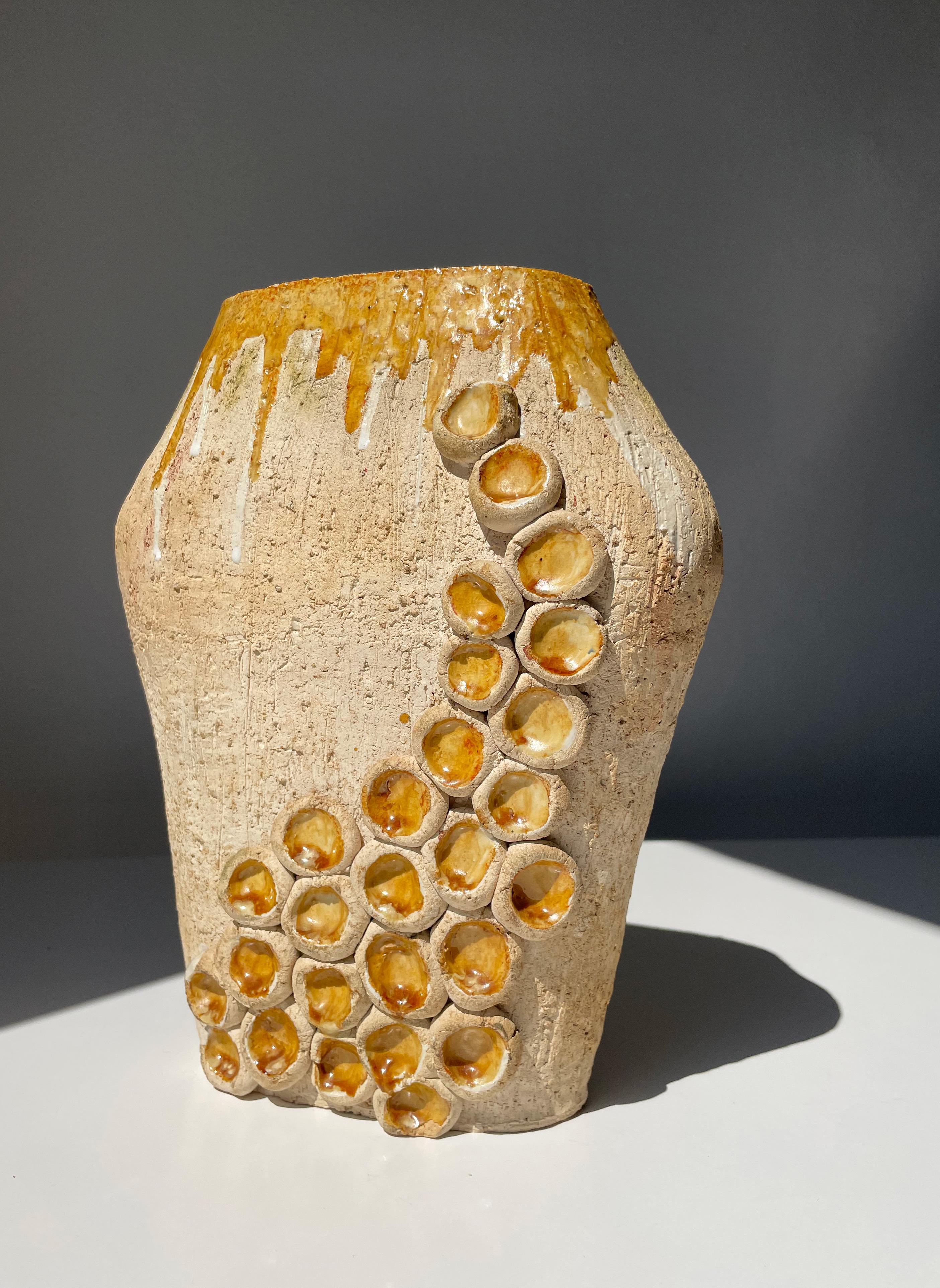 Large and heavy handmade Danish Modern ceramic decorative sculptural vase with unusual and soft shaped organic decorations. Rustic shiny warm yellow ochre colored glaze on the inside seemingly spilling over and creating running glazed lines along