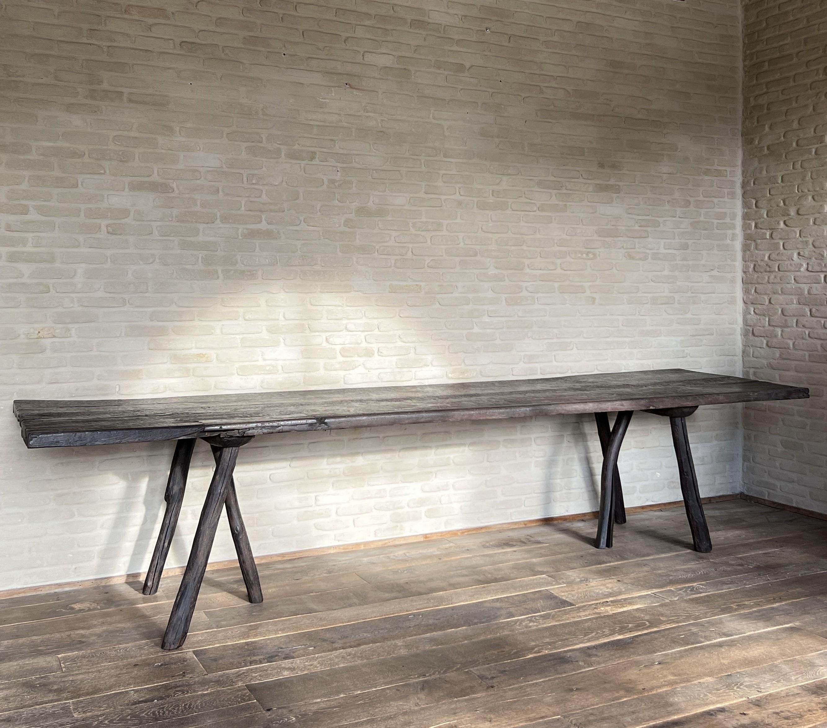 We made this table starting from a 19th century hardwood 3 plank top. Inspired by brutalism, organic furniture and 16th century refectory tables we decided to add tripod feet made from reclaimed early 20th century fencing posts. All the time