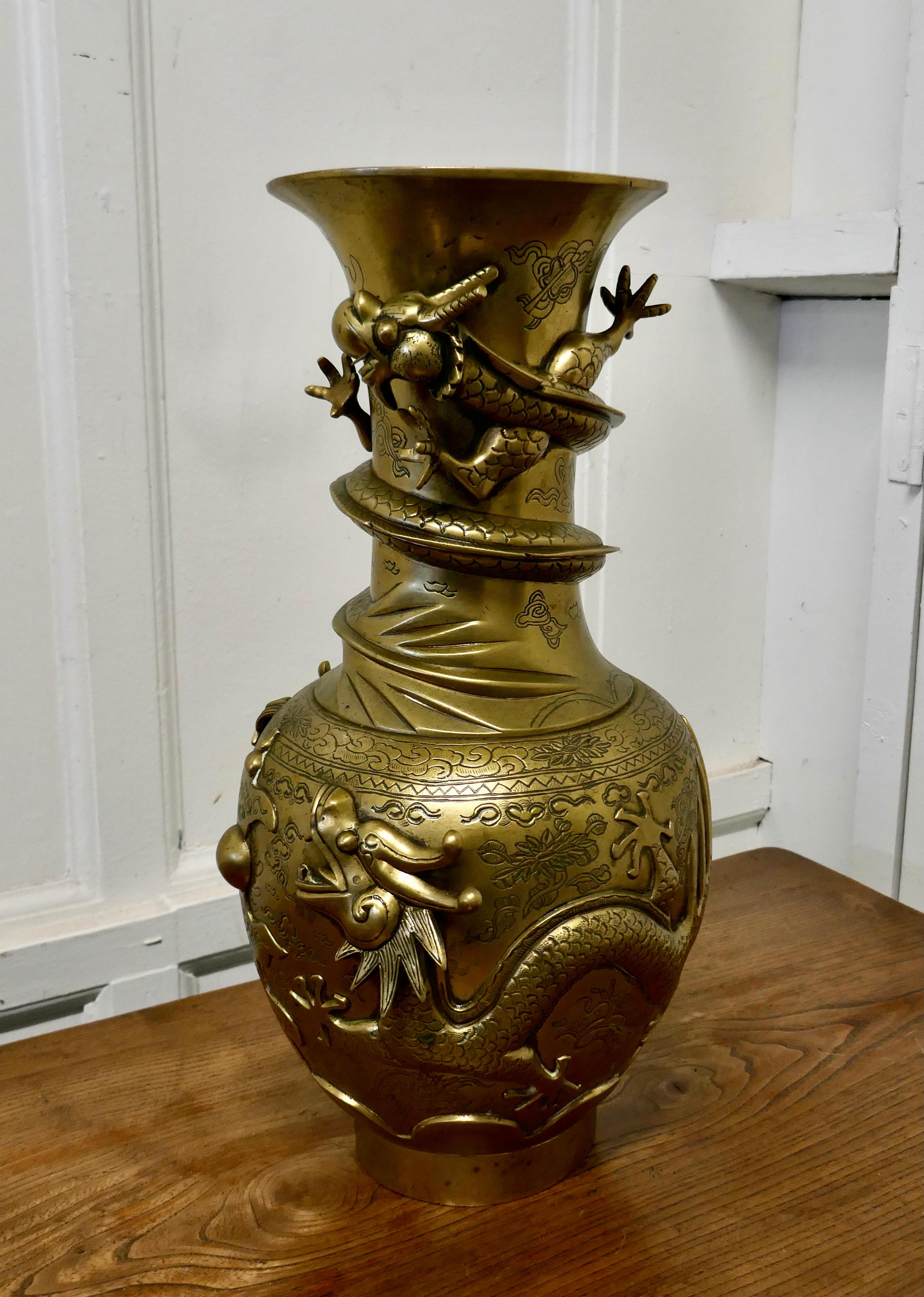 Large Oriental 19th century decorated brass vase

This is a large piece decorated in 3D with fierce Dragons and it has a very clear seal on the underside
The pot has a very old repair around the top otherwise it is in good original condition,