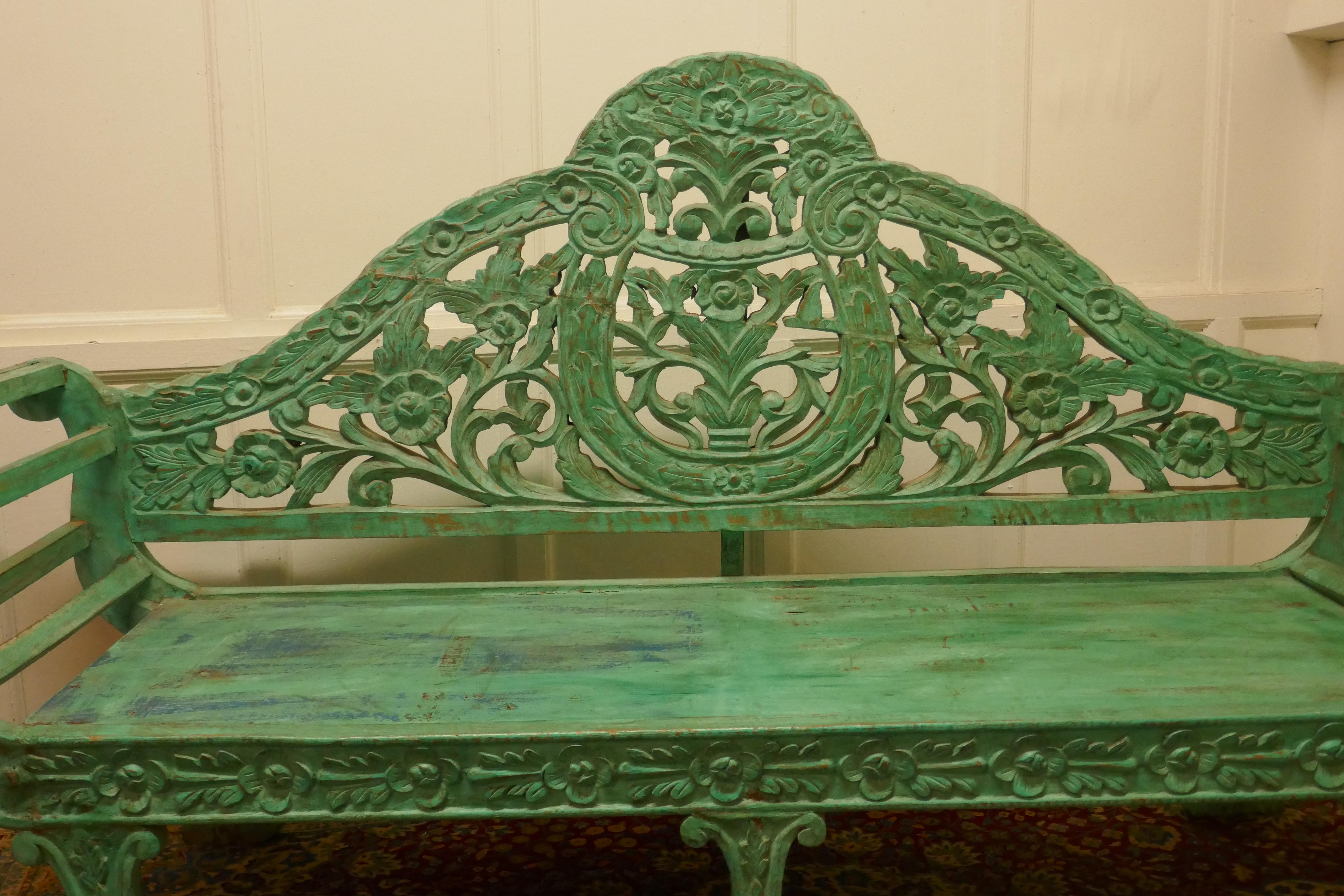 Large Anglo Indian Teak Carved Painted Settee, Bench

This is an unusual piece, the settee or bench is painted in green and has has a very intricately carved high back 
The bench is in good all round condition and has an outward curved shape to the