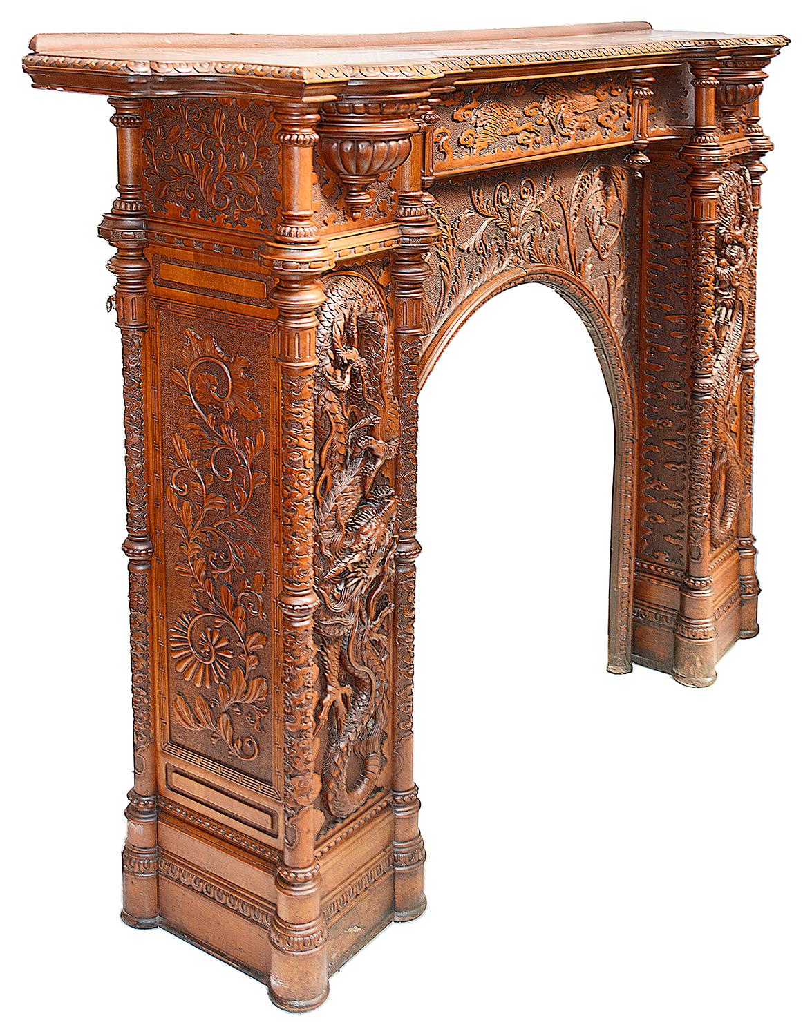 A rare and spectacular large Japanese carved wood fire place, having wonderful carved panels to the pelmet depicting cranes flying amongst clouds, turned columns and reeded brackets. Either side having wonderful mythical dragons entwinned between