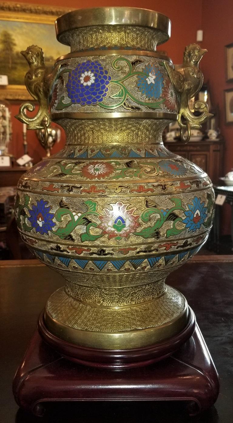 Presenting a beautiful and very high quality large oriental champlevé cloisonné urn on stand.

Late 19th or early 20th century, circa 1890-1910.

Probably Japanese in the Archaistic Chinese style.

Marked, but we cannot decipher the