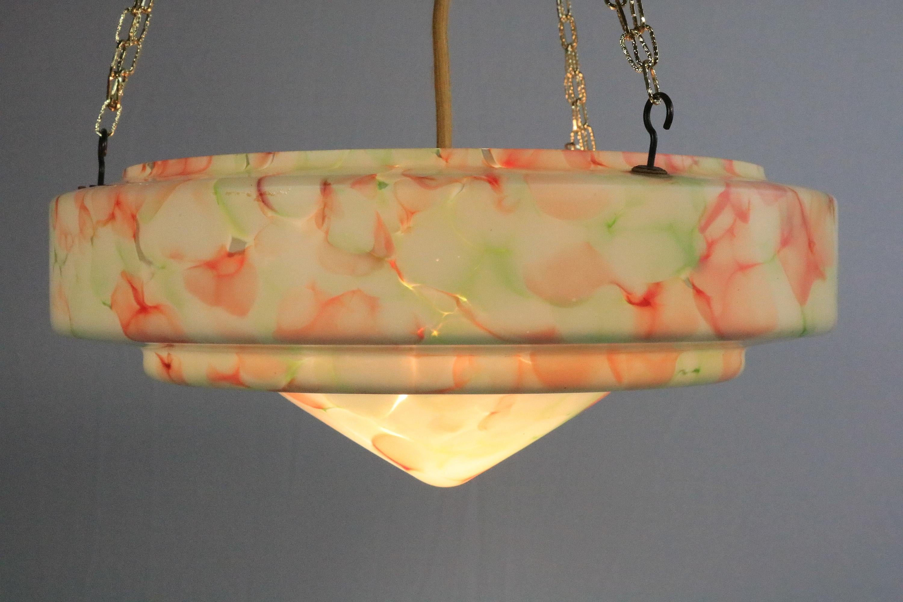 Very decorative large glass lamp hanging on a golden chain.
From the Art Deco period, ca. 1940.

Exceptionally beautiful marbling and perfectly preserved glass. All other parts are new.

The E27 socket is fitted with a gold-colored textile cable
