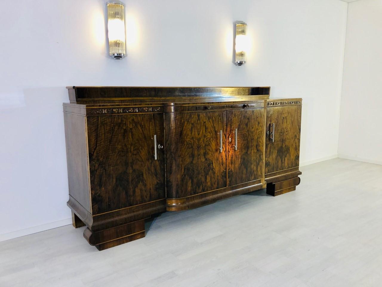 Large and classic original Art Deco sideboard or buffet made of luxurious, dark walnut wood. Offers unique cherry ornamentation around the top plate (107cm height), a huge hutch (120cm height), as well as a serving extension made of oak wood. This