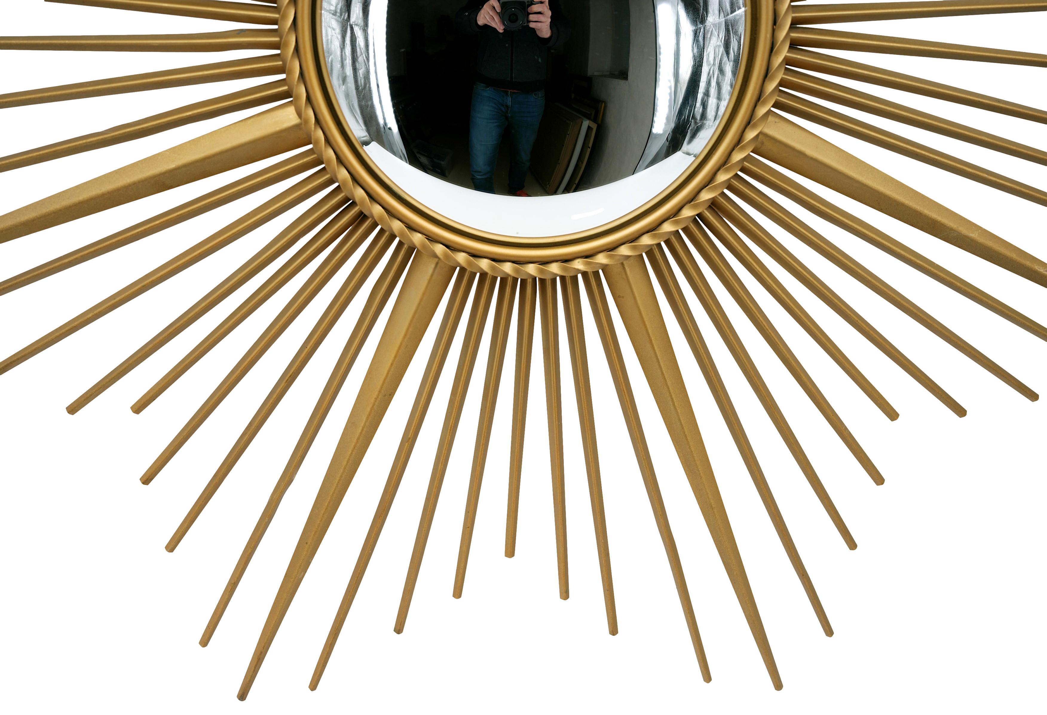 Large sun wall mirror by CHATY Vallauris, Alpes-Maritimes, France, 1950s. Patinated gold. Diameter : 35.4