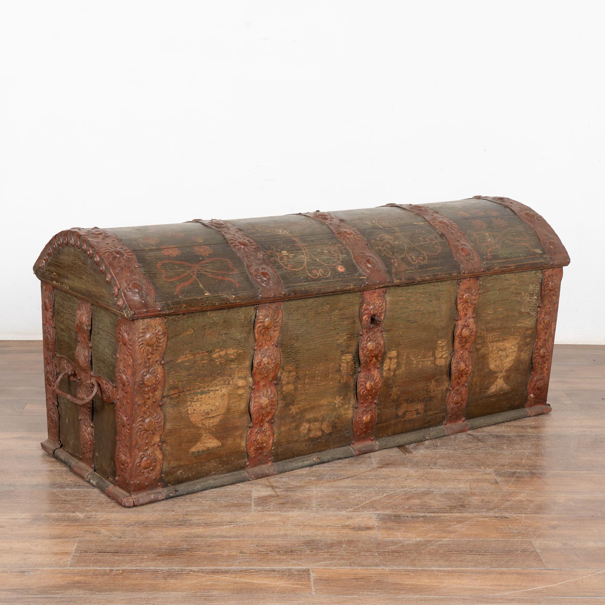 Original green painted dome top oak trunk from Denmark with wrought iron straps and side handles.
Faded monogram and date 