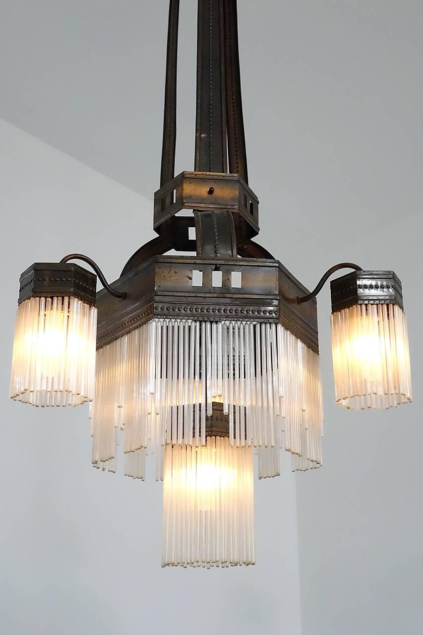 You can call this distinctive lamp Jugendstil or Art Nouveau and the look is amazing. The style is very distinctive. This lamp has all of its hand blown hollow glass rods with no damage, and there are at least 300 of them. The darkened copper finish