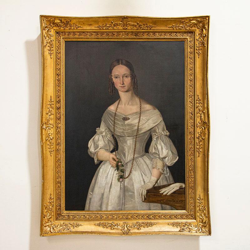 Large, lovely original oil on canvas painting of Julie Glad, née Kanneworff (1821–1886), married to captain Carl Frederik Glad (1803–1862). This is possibly a wedding portrait, with the Captain's wife wearing white bridal satin and gloves. Notice