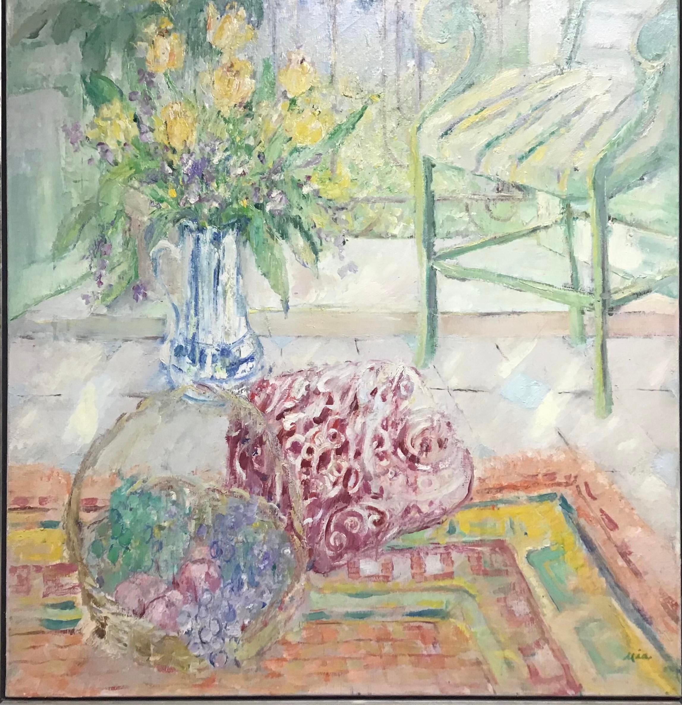 Lovely large original oil on canvas still life painting of vase of flowers sitting on a table in front of a window next to a chair. Impressionist style with heavy impasto paint in colorful style. Housed in a thin modern silver gilt frame. Signed Mia