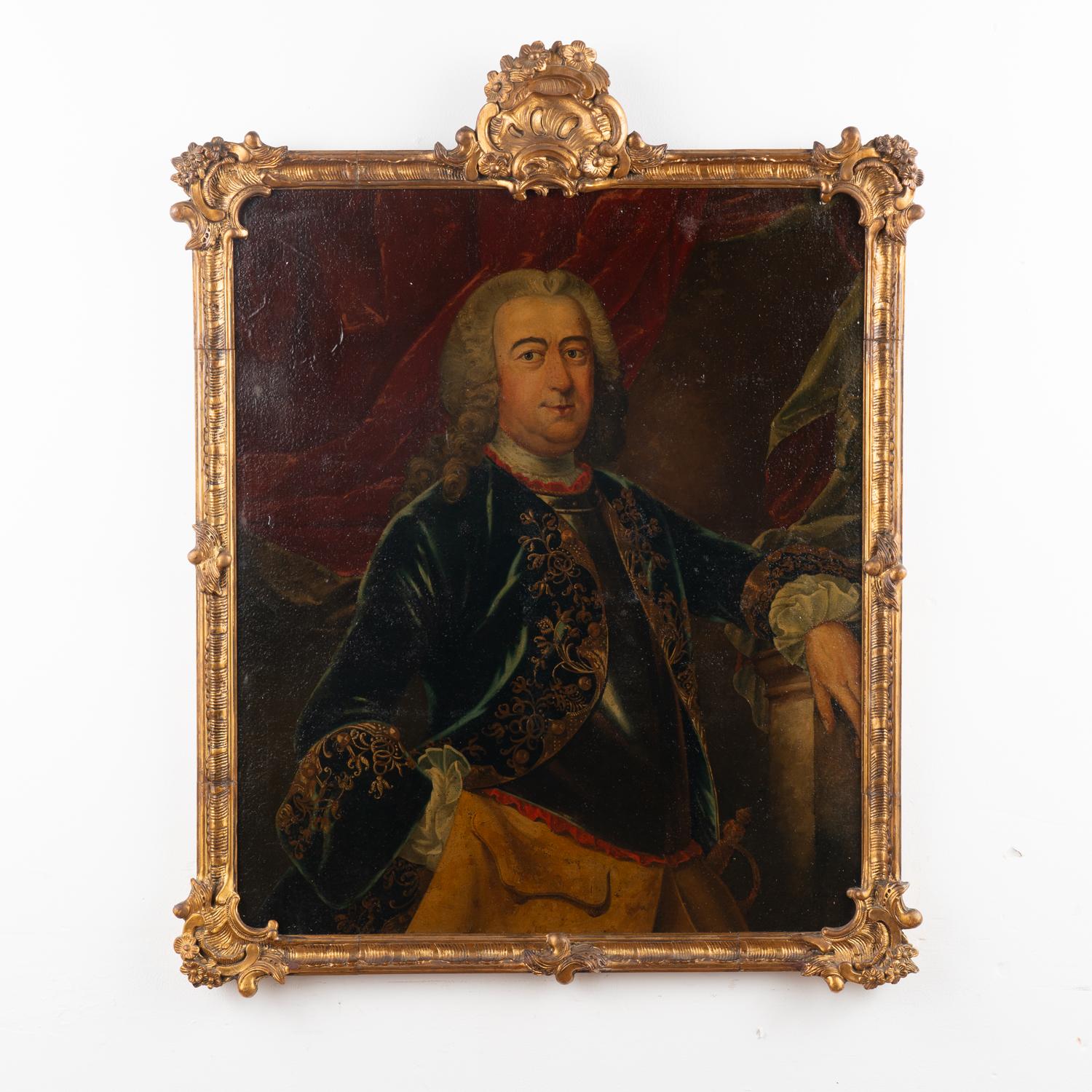 Large portrait of a gentleman wearing a blue coat with golden embroidery. Oil on canvas laid on panel.
Unsigned. Painter unknown, 18th century. Possible portrait of a monarch.
Has craquelure and retouches throughout. Canvas will benefit from