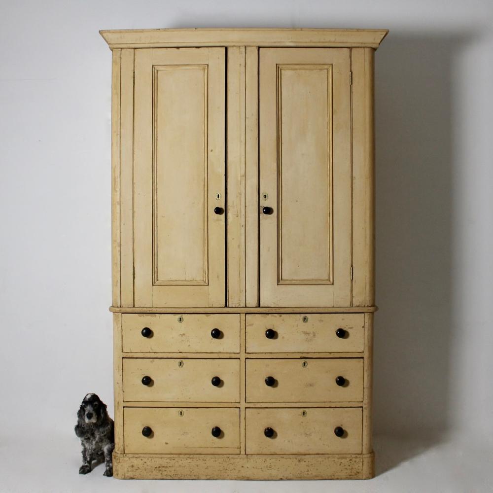 A glorious large scale English country house pine housekeeper’s cupboard, dating from early to mid-19th century. With six large, deep drawers and spacious cupboards above, retaining its original handles, the whole taken back to its original