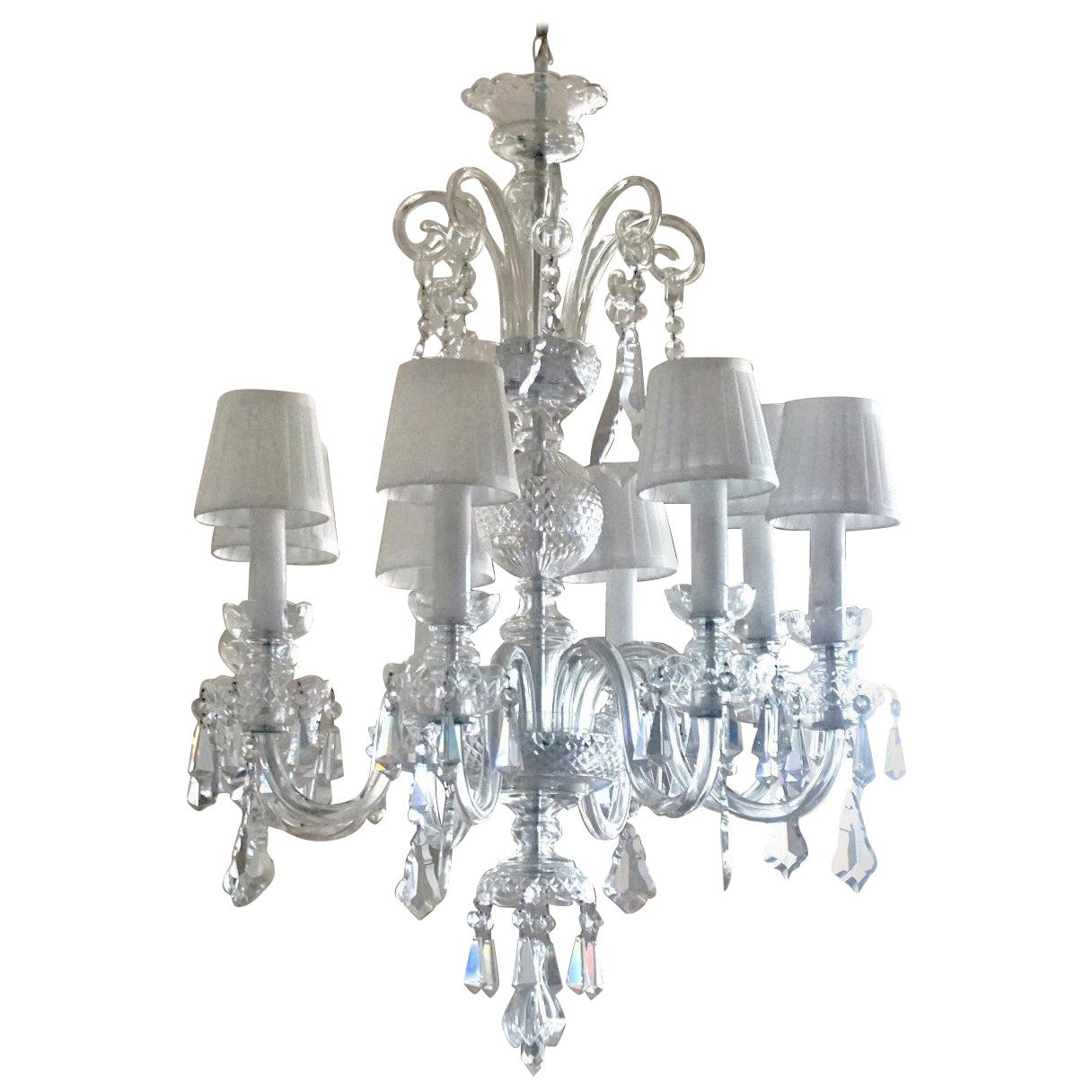 A rare original Venetian handcrafted crystal eight-light chandelier, Italy, 1910-1920. Eight hand blown Murano scroll lamp arms with candelabra light sockets surrounded by glass candle covers. This very elegant chandelier is decorated with eight