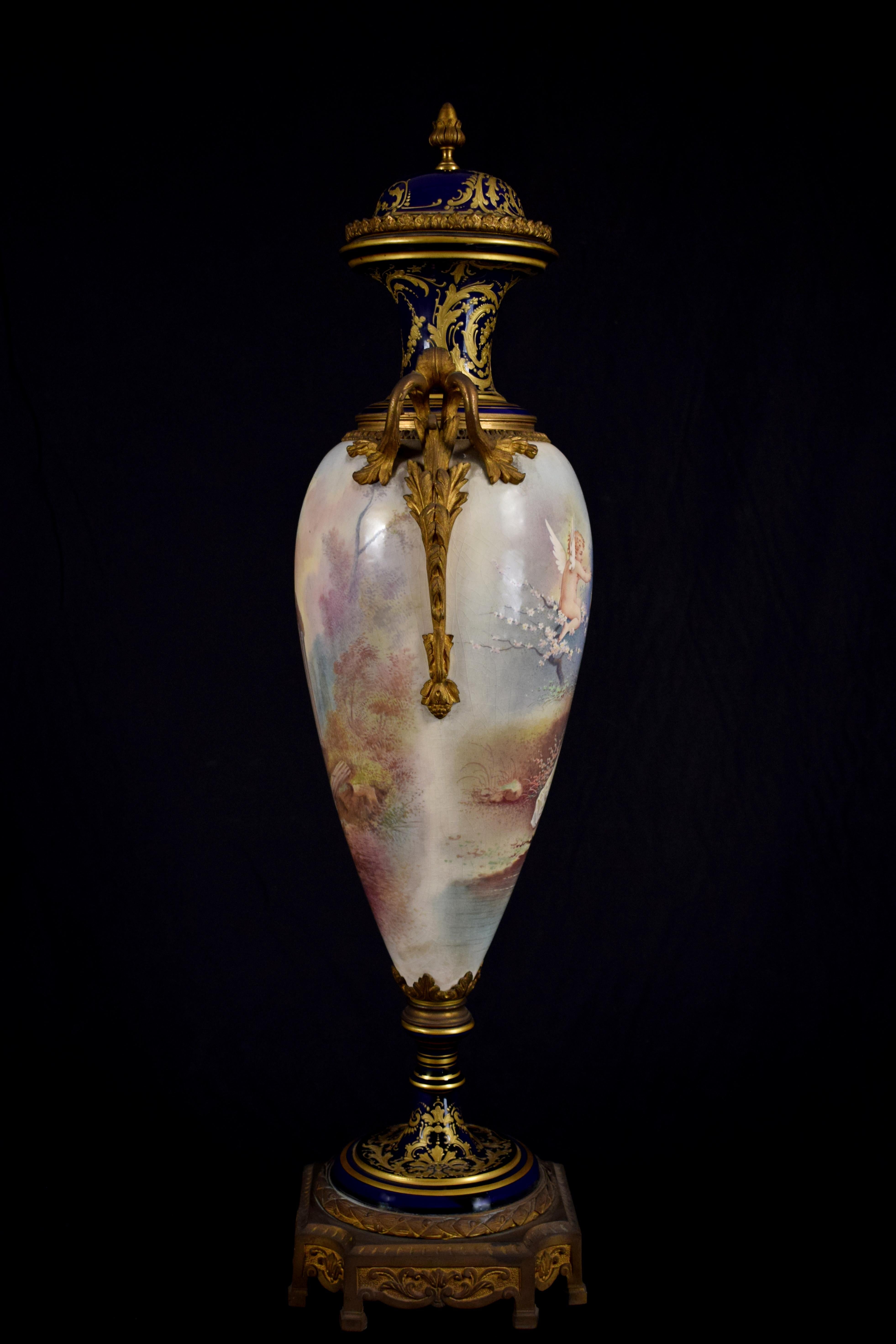 A fine quality French Sèvres style porcelain vase, late 19th century, in porcelain cobalt-blue, finely painted and decorated with gilt bronze. The painting represent “Cupid and Venus”. Cupid is depicted as a child, with two wings on his back, and he