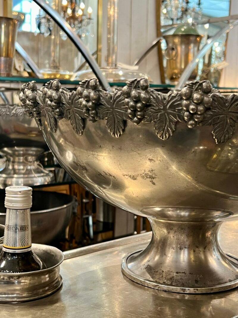 Handsome and large old champagne cooler, from France.  Rarely found size, so can store 5-6 bottles. 

Made of solid quality tin, with charming raised ornamentation of vine leaves and grapes draped like garlands right at the edge, giving a lovely