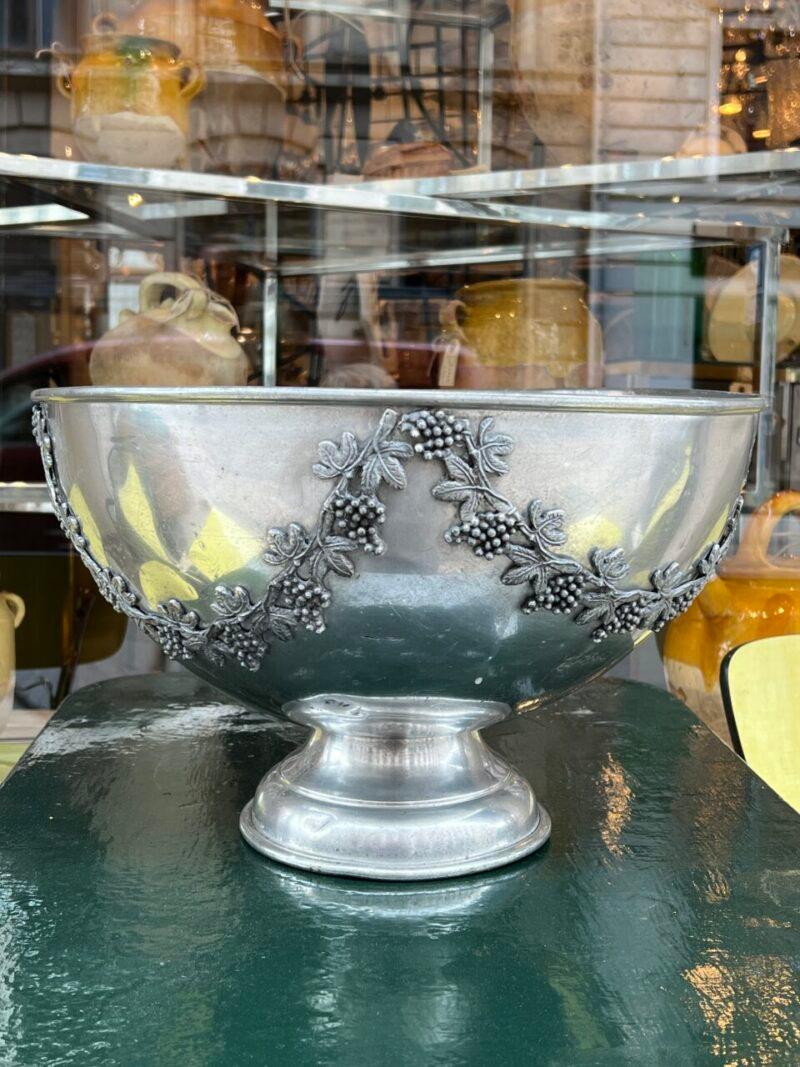 Handsome and large old champagne cooler, from France.  Rarely found size, so can store 5-6 bottles. 

Made of tin, with charming raised ornamentation of vine leaves and grapes draped like garlands.

Just the right patina.

The perfect addition for a