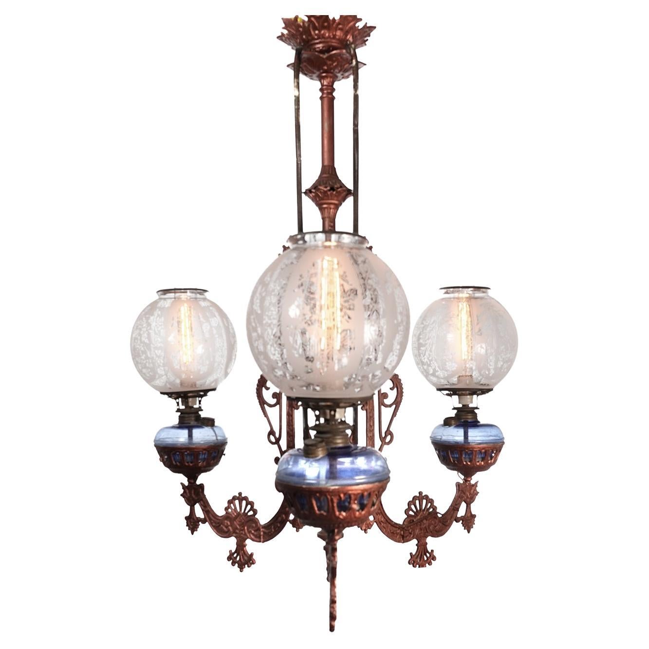 Not many of these large and impressive Eastlake oil chandeliers were made and few survive today. Lamps like this are often unsigned but are attributed to companies like Tucker or Bradley and Hubbard. Our best guess is 1860 by Tucker. There are three