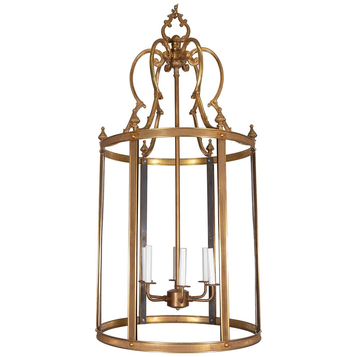 Large brass lantern with ornate finials and wrought details.