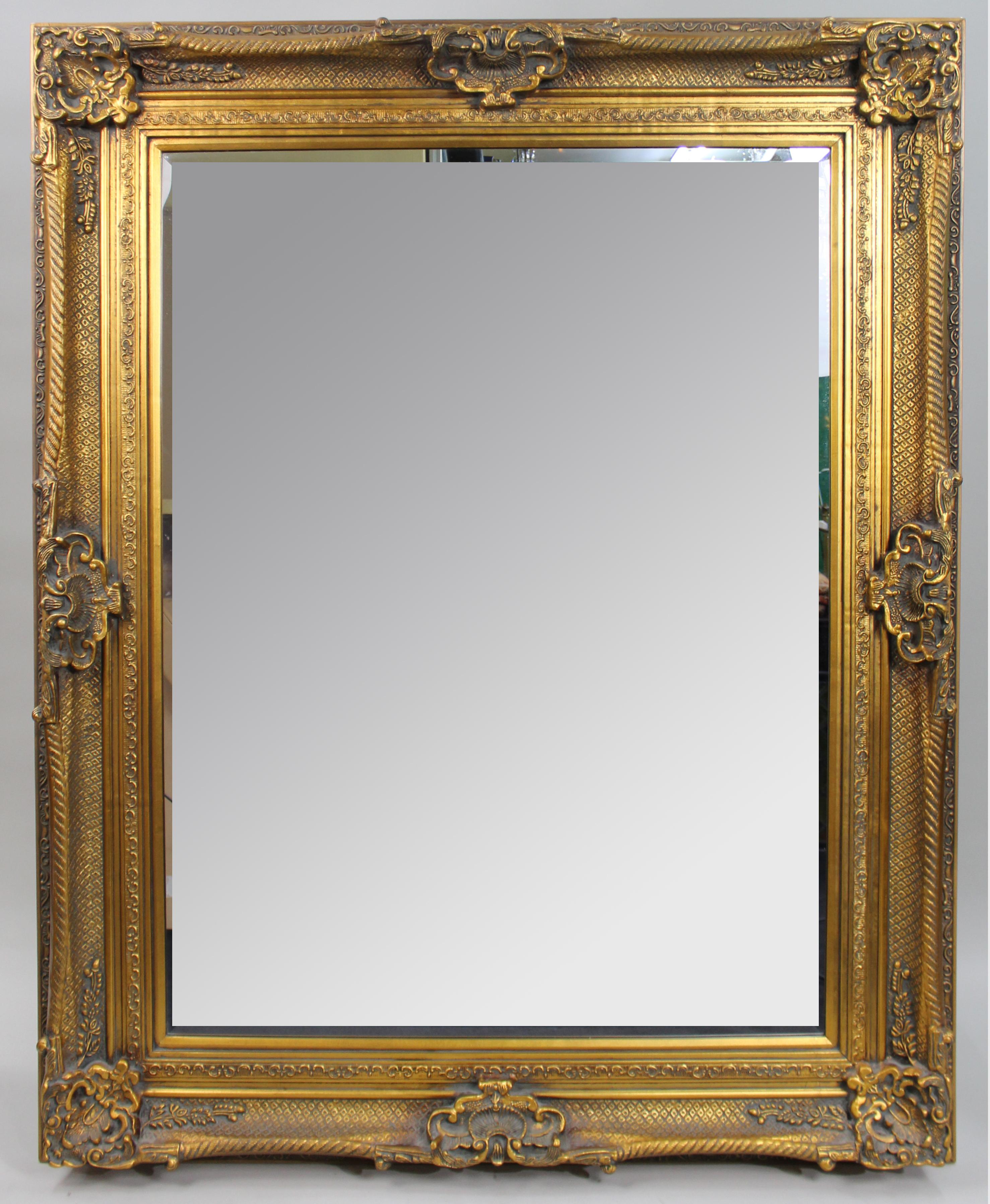 Large Antique Gilt Carved Wood Overmantel Mirror, c.1900

A bold and decorative antique overmantel mirror with a substantial carved wood frame and later gilt finish. Dating to the late Victorian or early Edwardian period, the frame is adorned with
