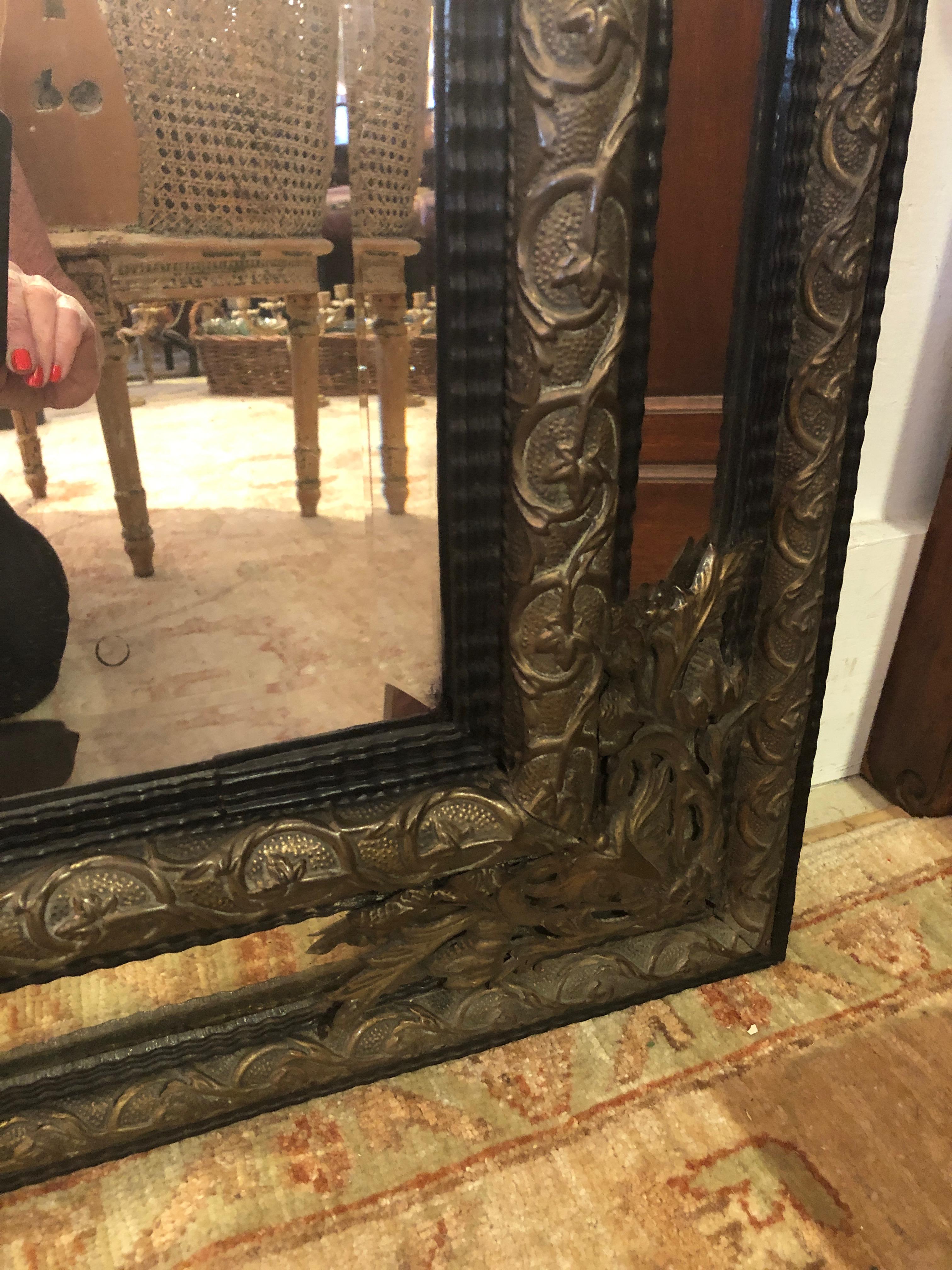 Large Ornate Repousee Brass and Ebonized Cushion Mirror In Excellent Condition In Hopewell, NJ