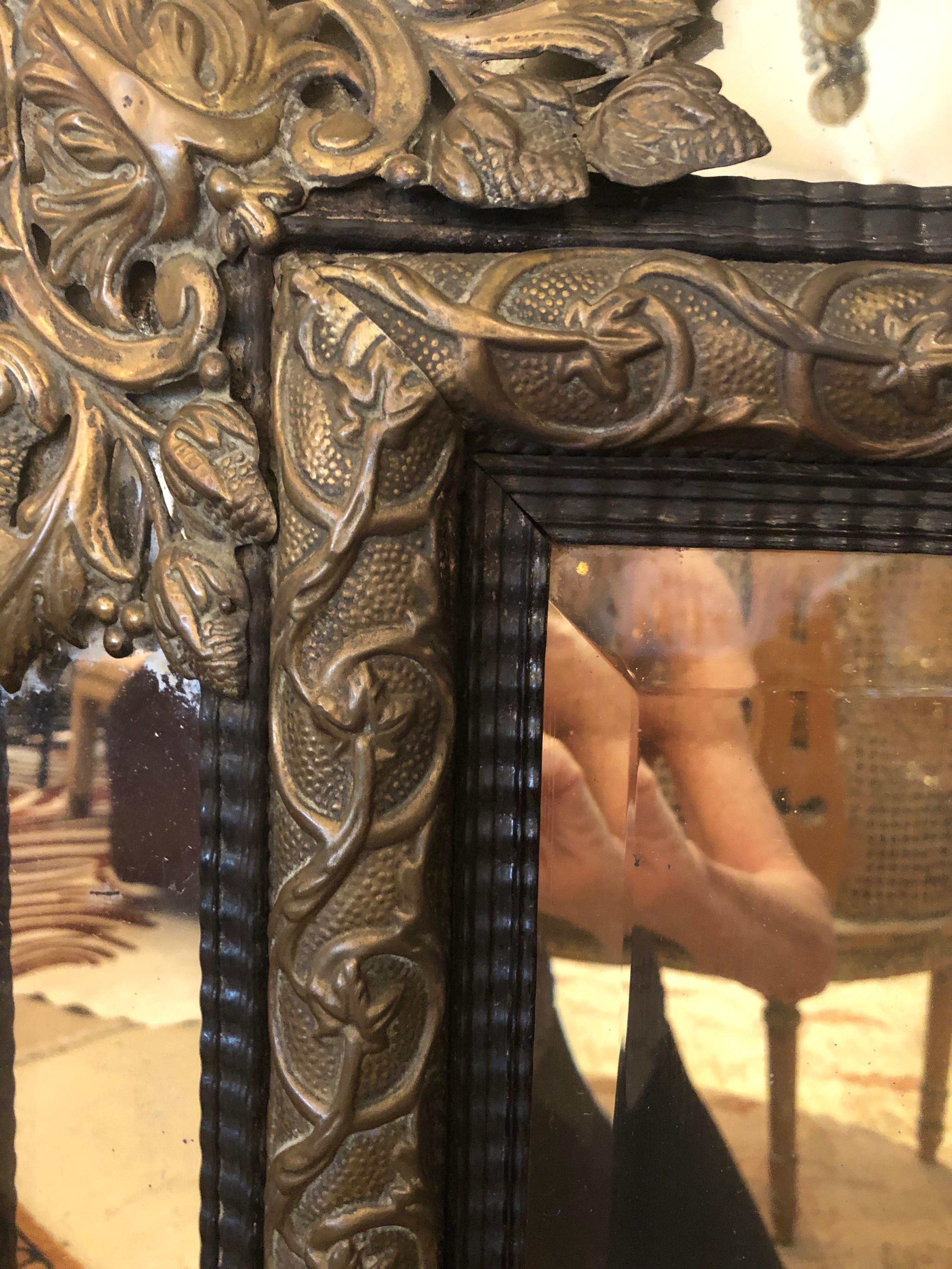 Large Ornate Repousee Brass and Ebonized Cushion Mirror 1