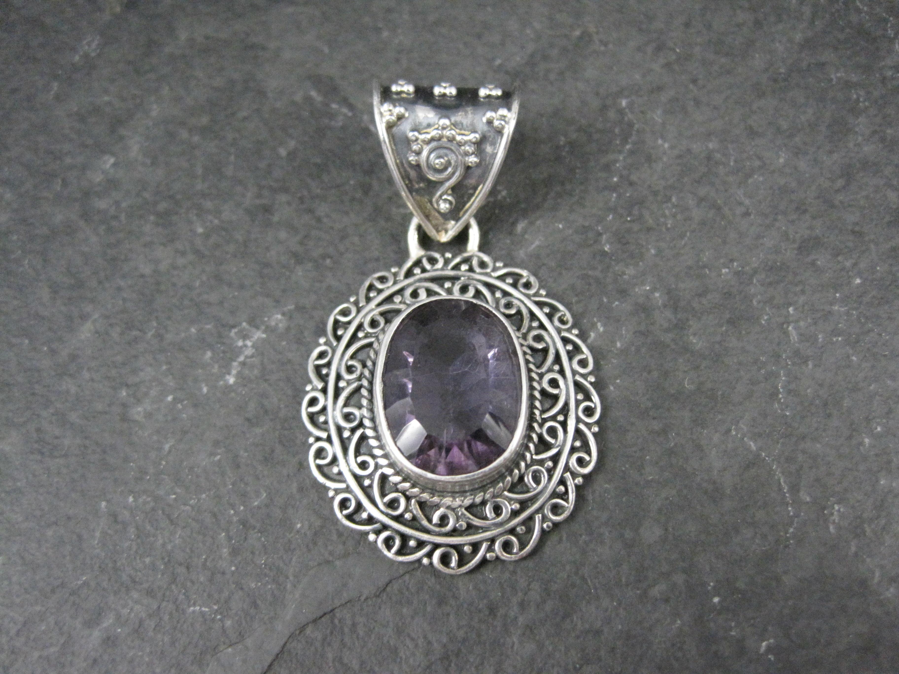 This gorgeous balinese sterling pendant features a large oval cut amethyst gemstone.

The amethyst measures 11x15x6 mm and is estimated to be around 6 carats.

The pendant measures 1 1/16 by 1 3/4 inches, including the bail.
The bail will
