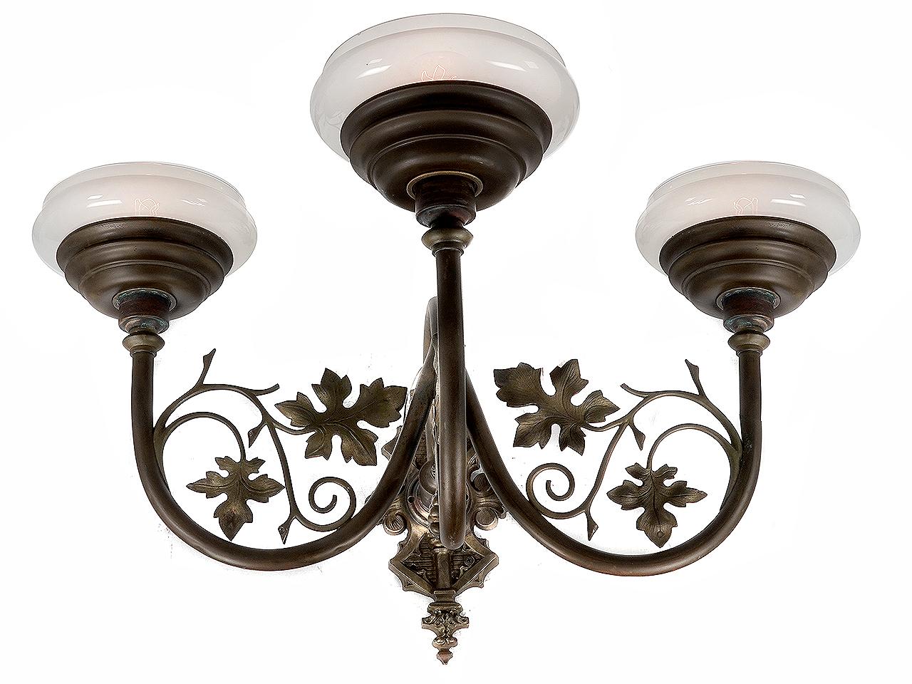 This is a large and impressive ornate sconce that makes a big statement. The Vaseline glass has a nice mellow grapefruit color and the hand blown glass is light and delicate. The metal is an intricate combination of curved tubing and floral work.
