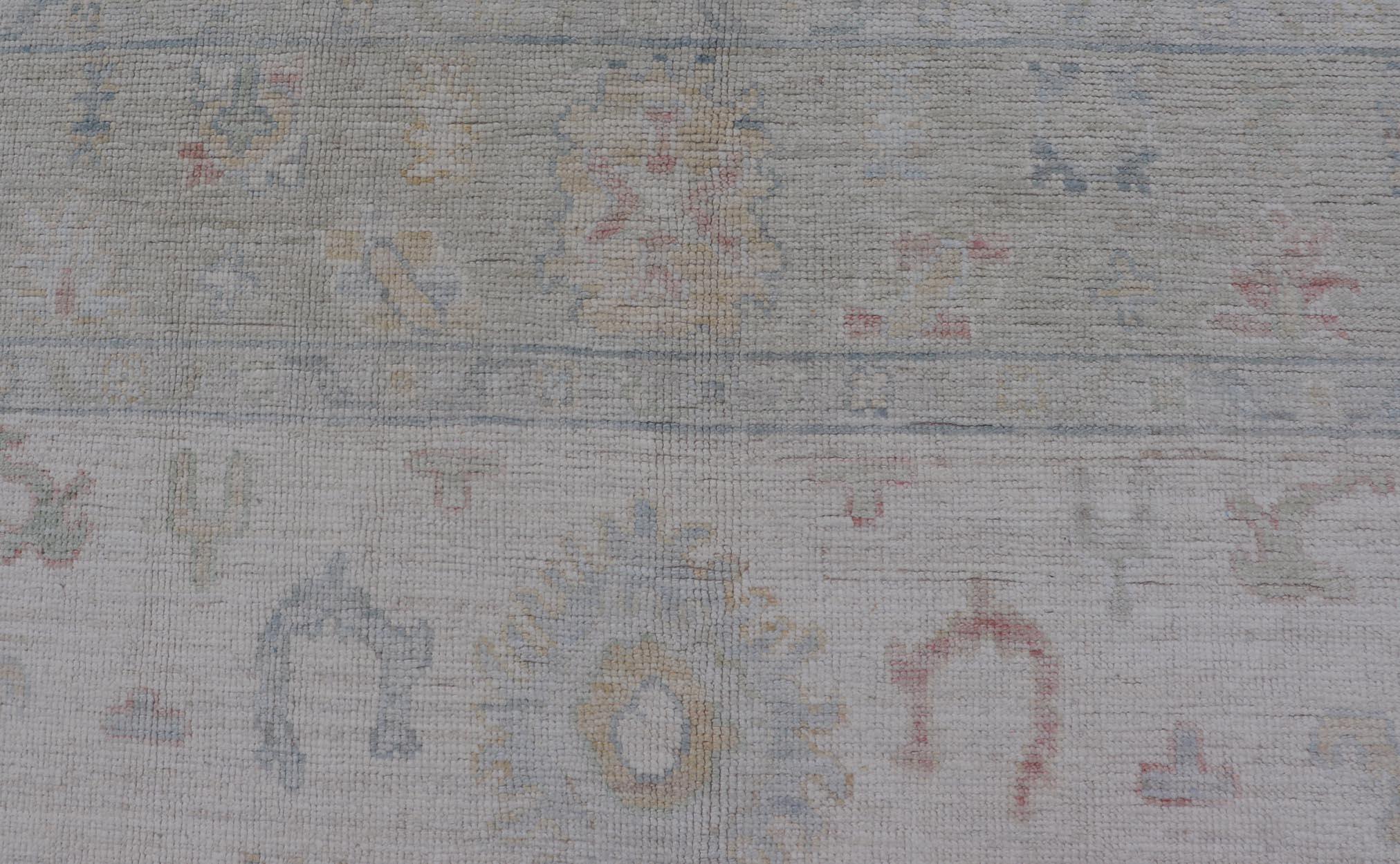 Large Oushak Rug with Floral Motifs & Muted Colorful Tones on Neutral Background. Keivan Woven Arts; rug AWR-17881 Country of Origin: Afghanistan Type: Oushak Design.
Measures: 5'10 x 9'1 
This large Oushak has a border and background that are
