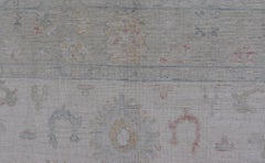 Large Oushak Rug with Floral Motifs & Muted Colorful Tones on Neutral Background