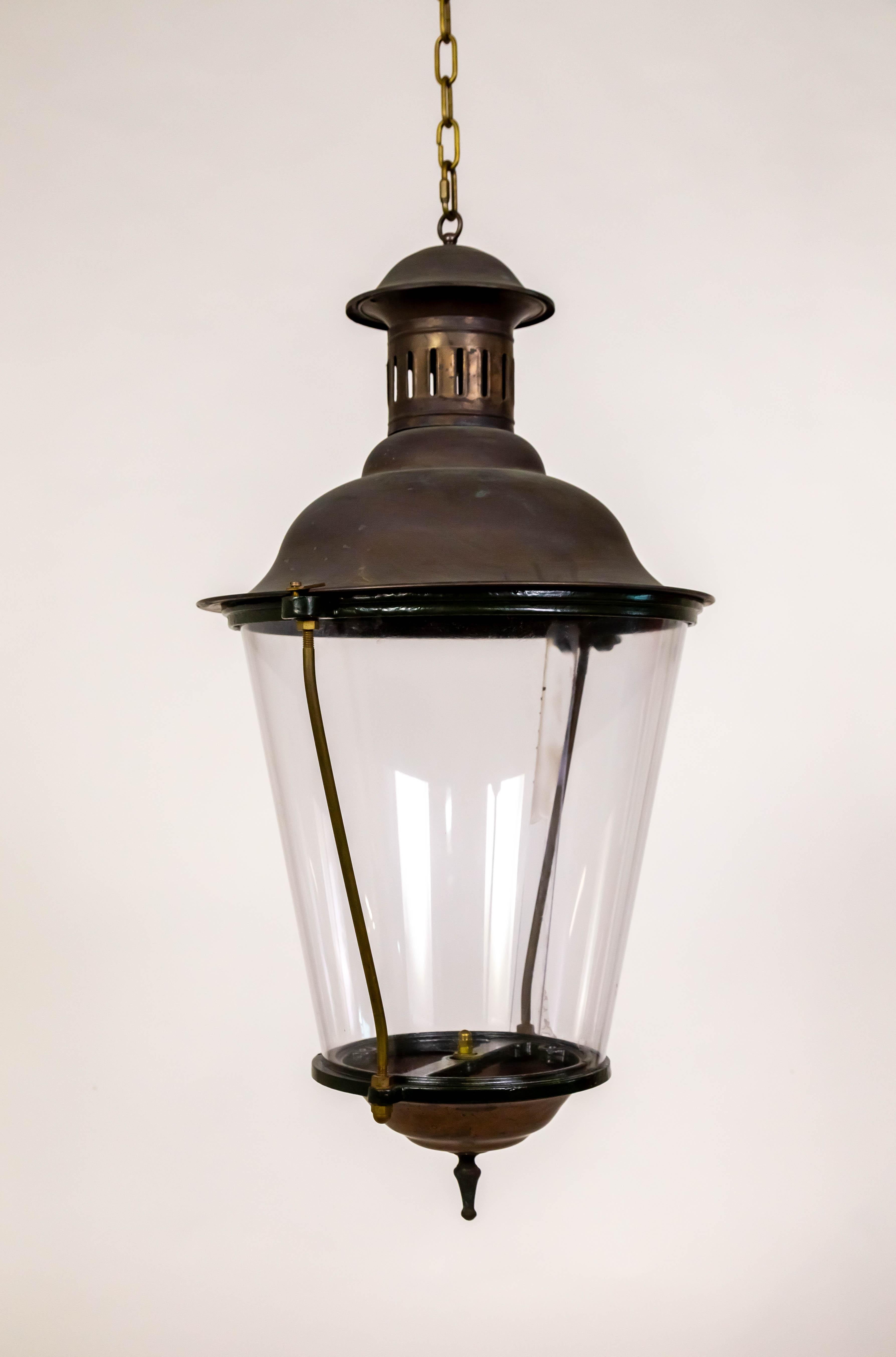 This lantern can be installed outdoors or indoors. It has patinated copper and brass caps and a lacquered dark green rim.  It is a tapered cylinder shape with an acrylic shade. Mid 20th century. Newly rewired with a standard size socket. 20