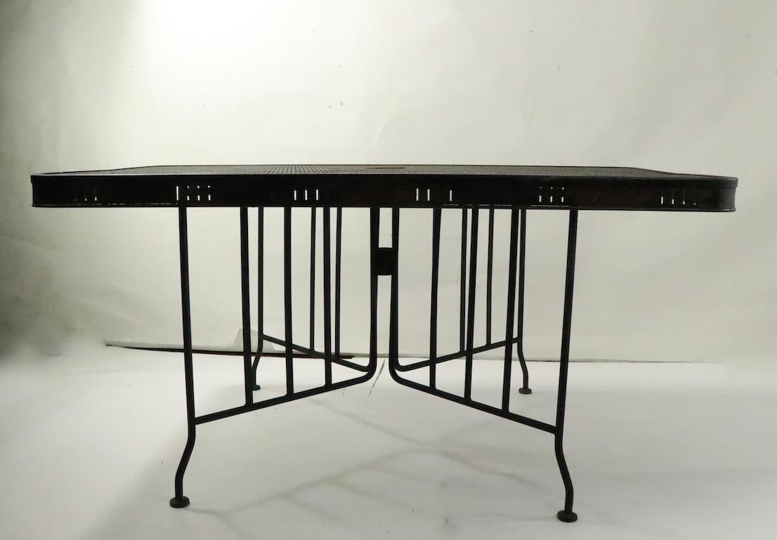 Large and impressive metal garden, patio dining table, having an unusual metal mesh top. Attributed to Meadowcraft, unsigned. Hard to find large scale outdoor tables, this is a nice modernist example, in good vintage condition, showing only minor