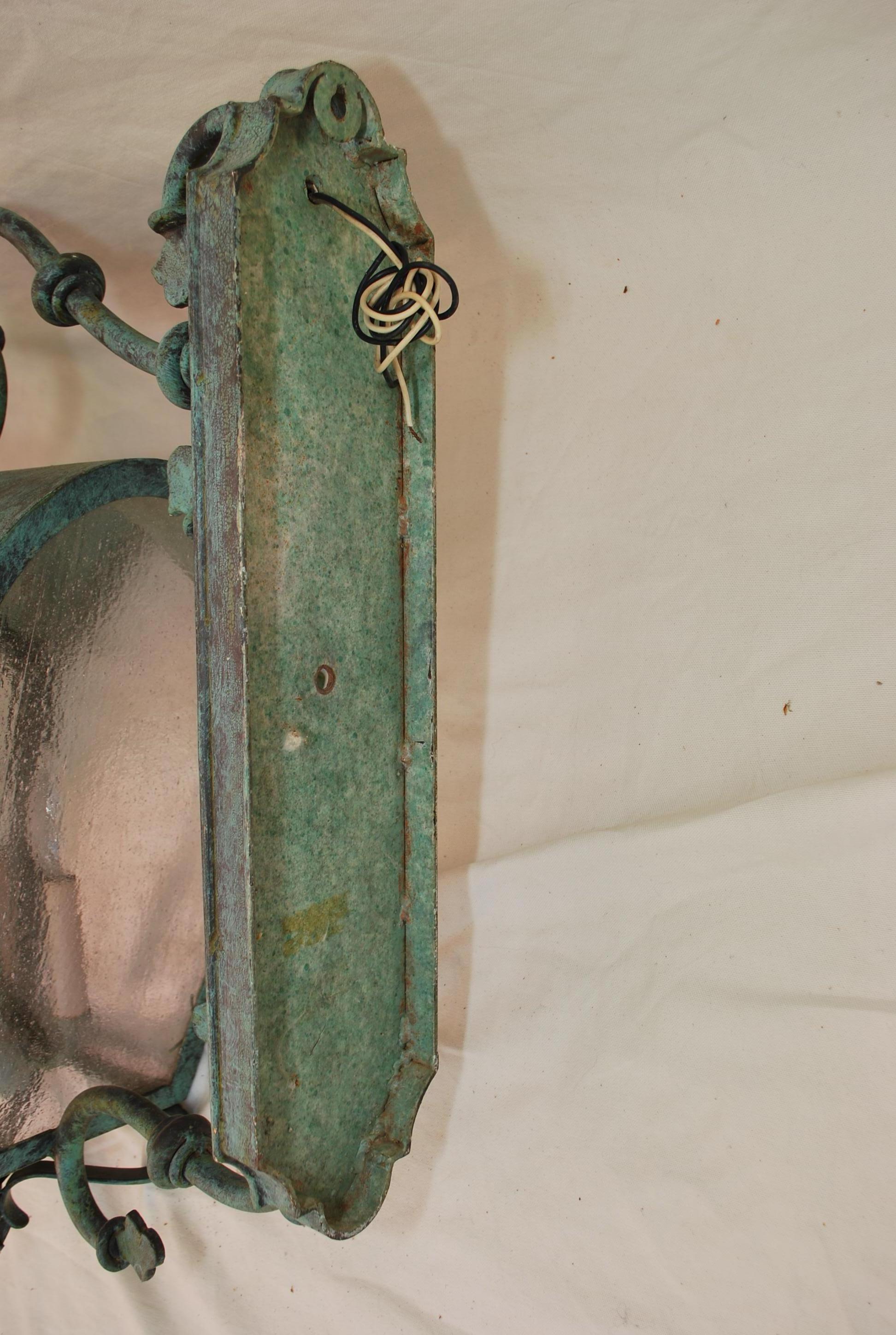 An elegant large pair of outdoor sconces, they are quite impressive in person, the patina is much nicer in person