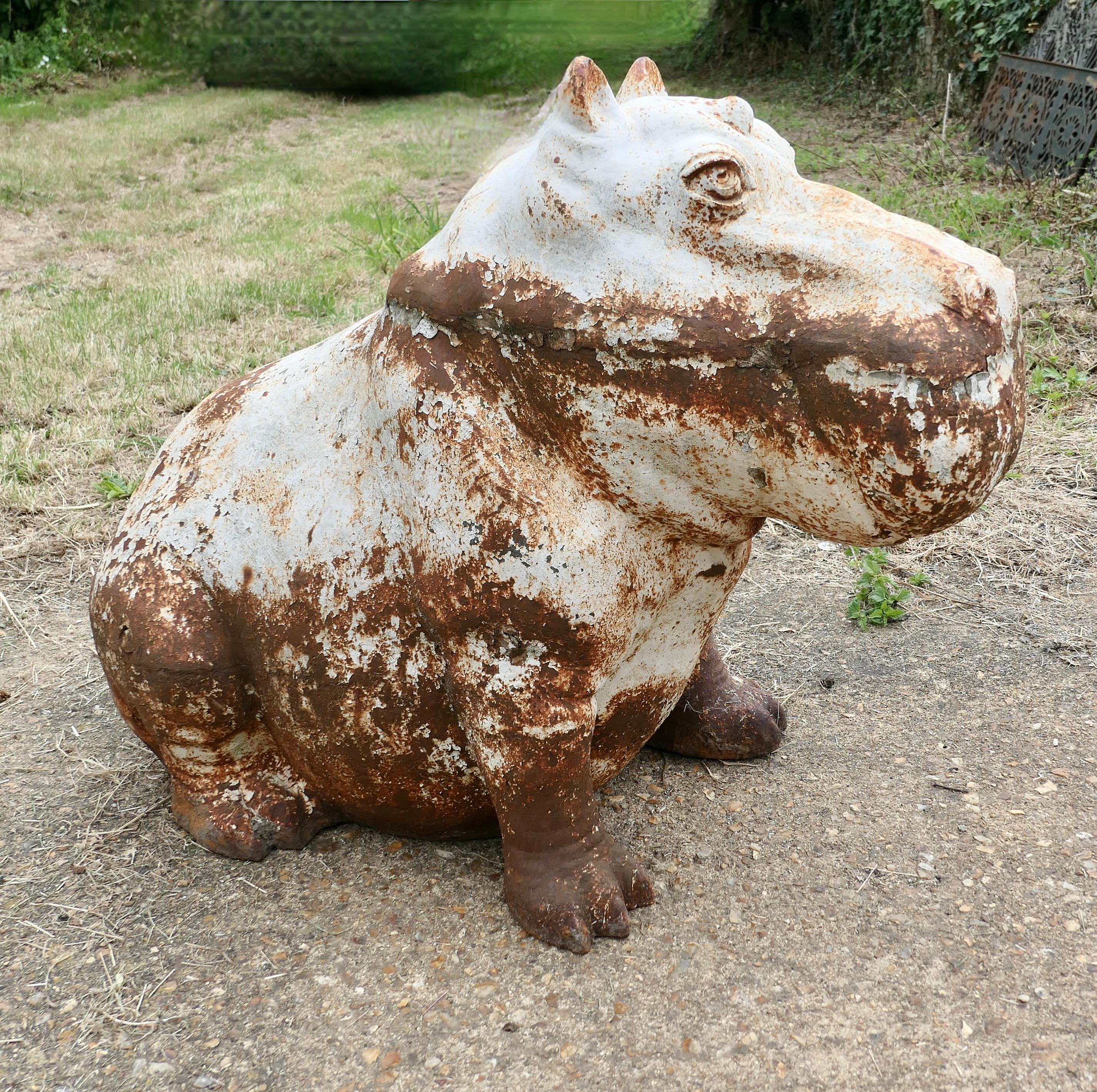 Large Outdoor Weathered Cast Iron Hippopotamus 

A Super chap he was painted white at one time, now he has a good outdoor patina (Rusty) 
The Hippo is in otherwise good condition with a beautifully Weathered patina 
Hippo is 26” tall, 17” deep and