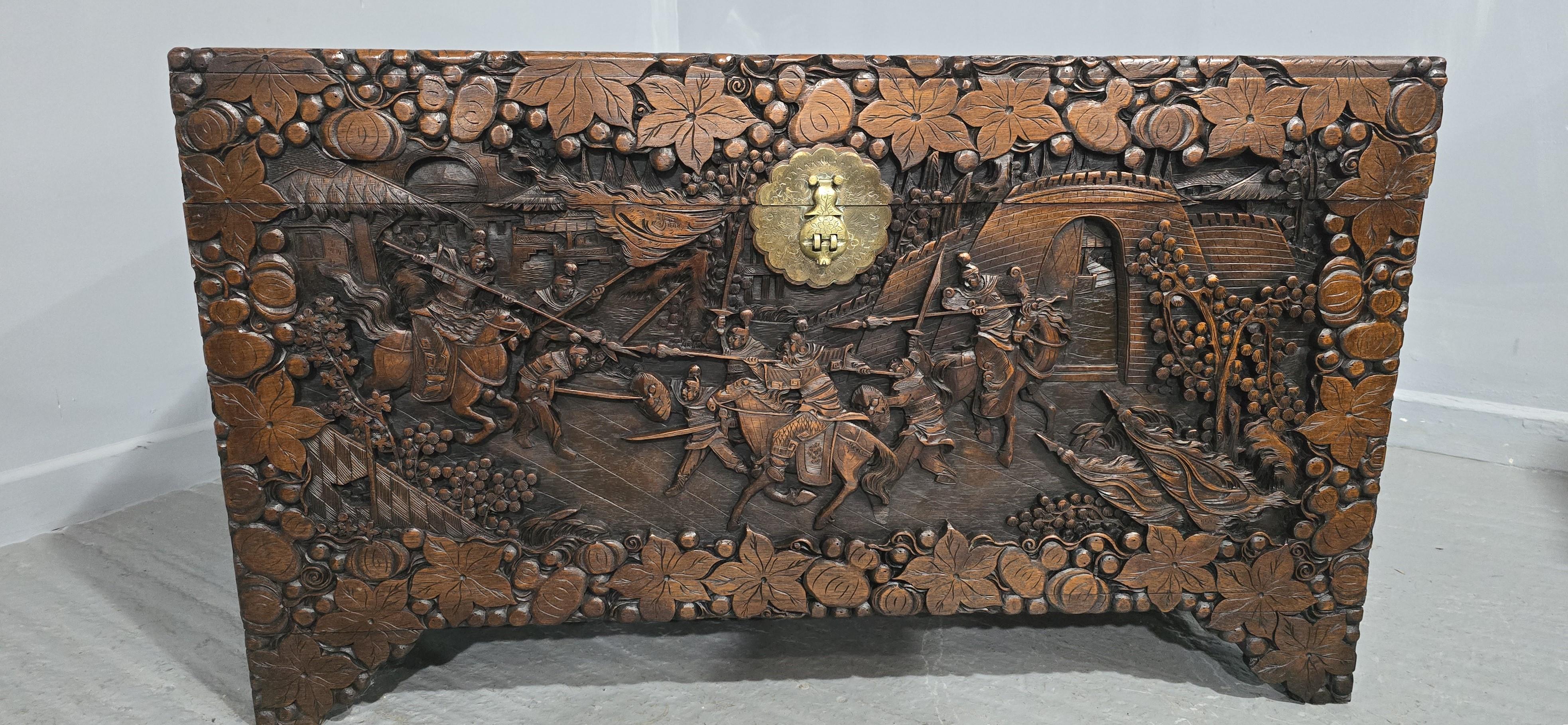 Superior carved camphor wood chest, with deep undercarving and wonderful , scenes, oversized with brass clasp, in excellent original condition.

25.5