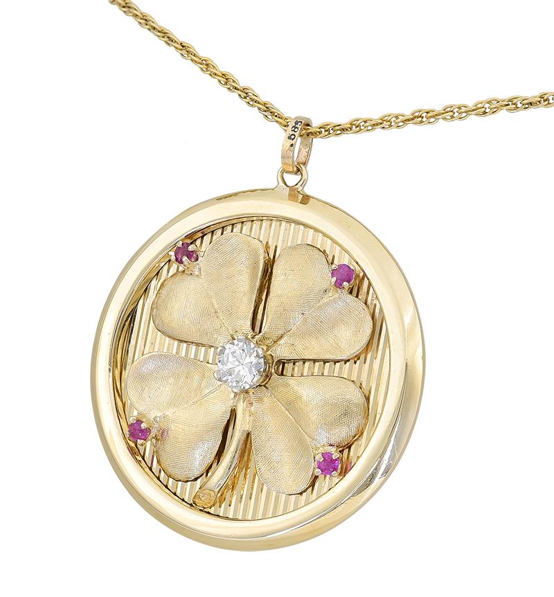 Fabulous large Love & Luck pendant/charm. On the front is a large textured figural four-leaf clover.  Set with a .65 carat faceted diamond and four bright faceted rubies.  Applied on a fine-line background, with a wide shiny gold border.  On the