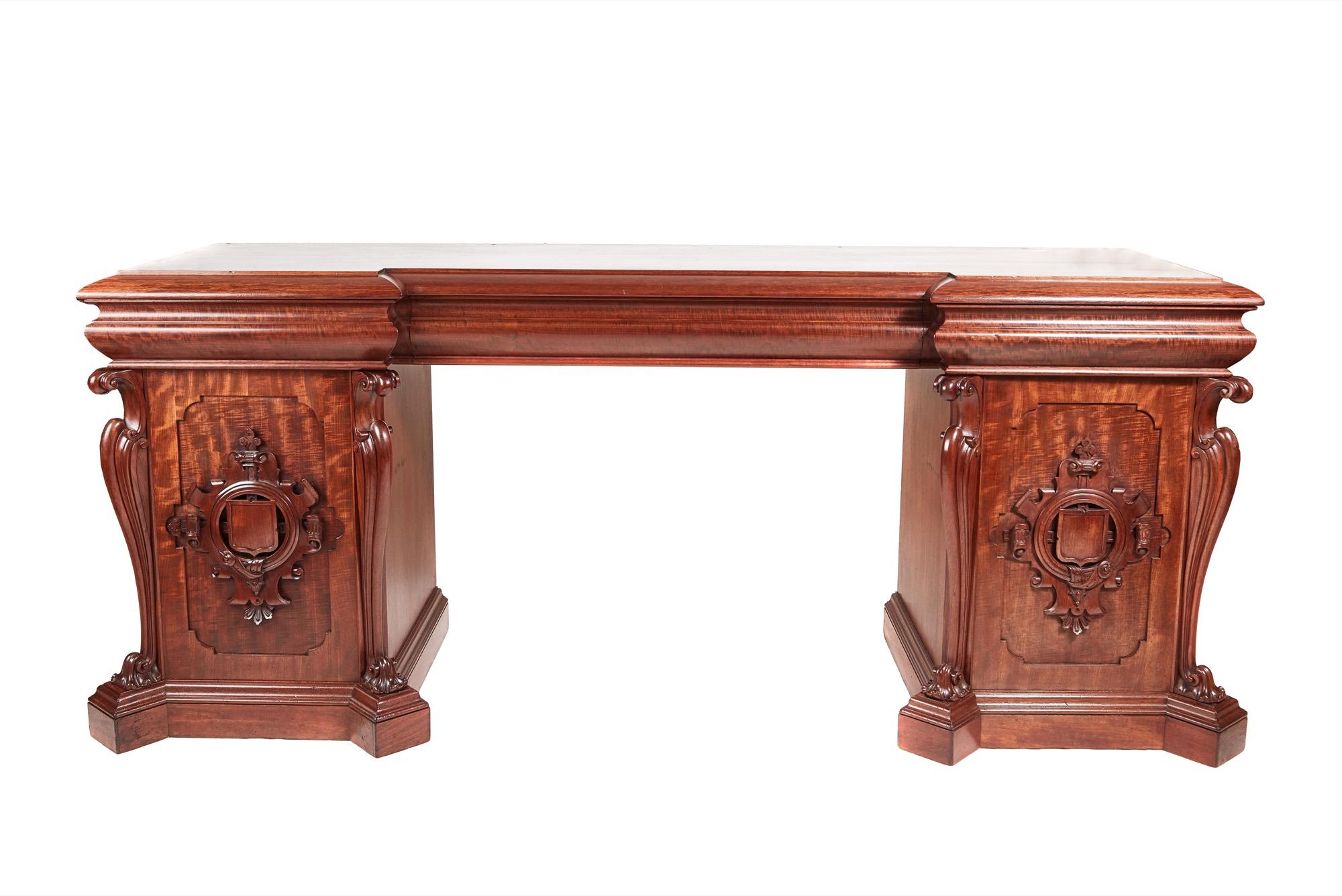 Large outstanding quality William IV antique carved mahogany sideboard with an exquisite flame mahogany inverted breakfront top with three shaped drawers to the frieze, supported by two carved mahogany cupboards with paneled doors and fabulous