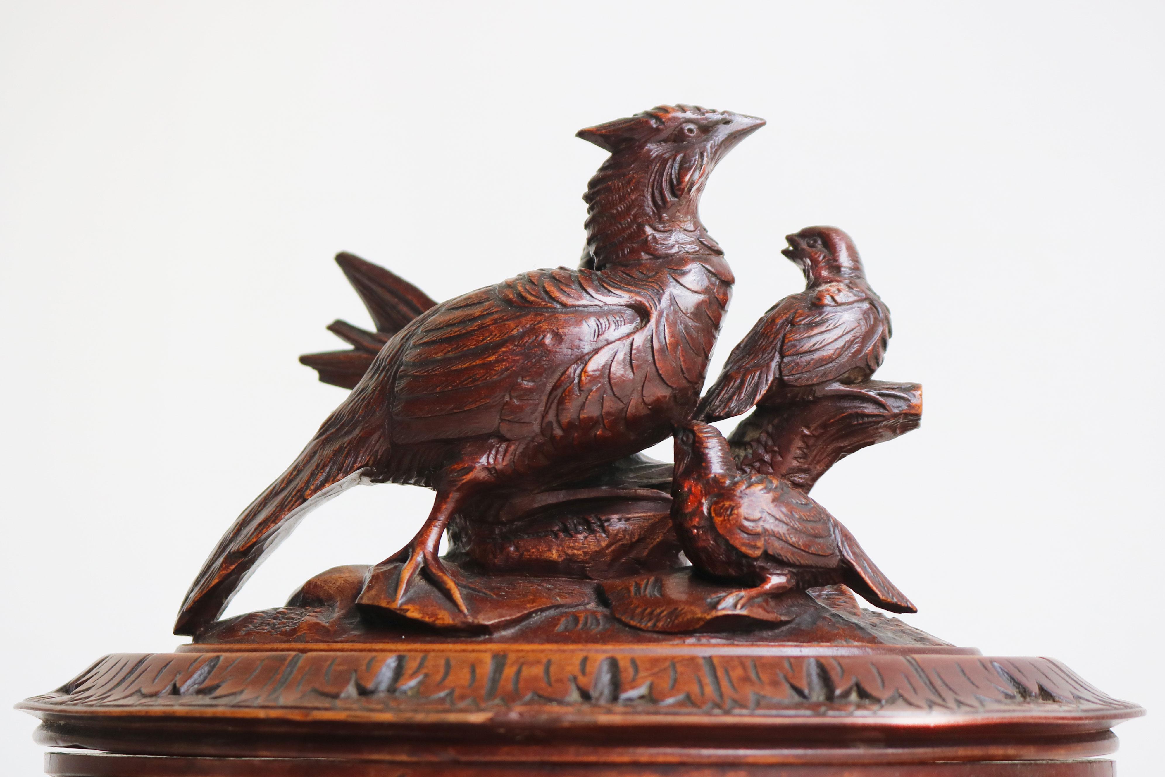 This stunning 19th-century Black Forest jewelry box from Switzerland is a true work of art, featuring a rare oval shape. Nearly 150 years old, the walnut wood has developed a remarkable patina that enhances its timeless beauty. The box is adorned