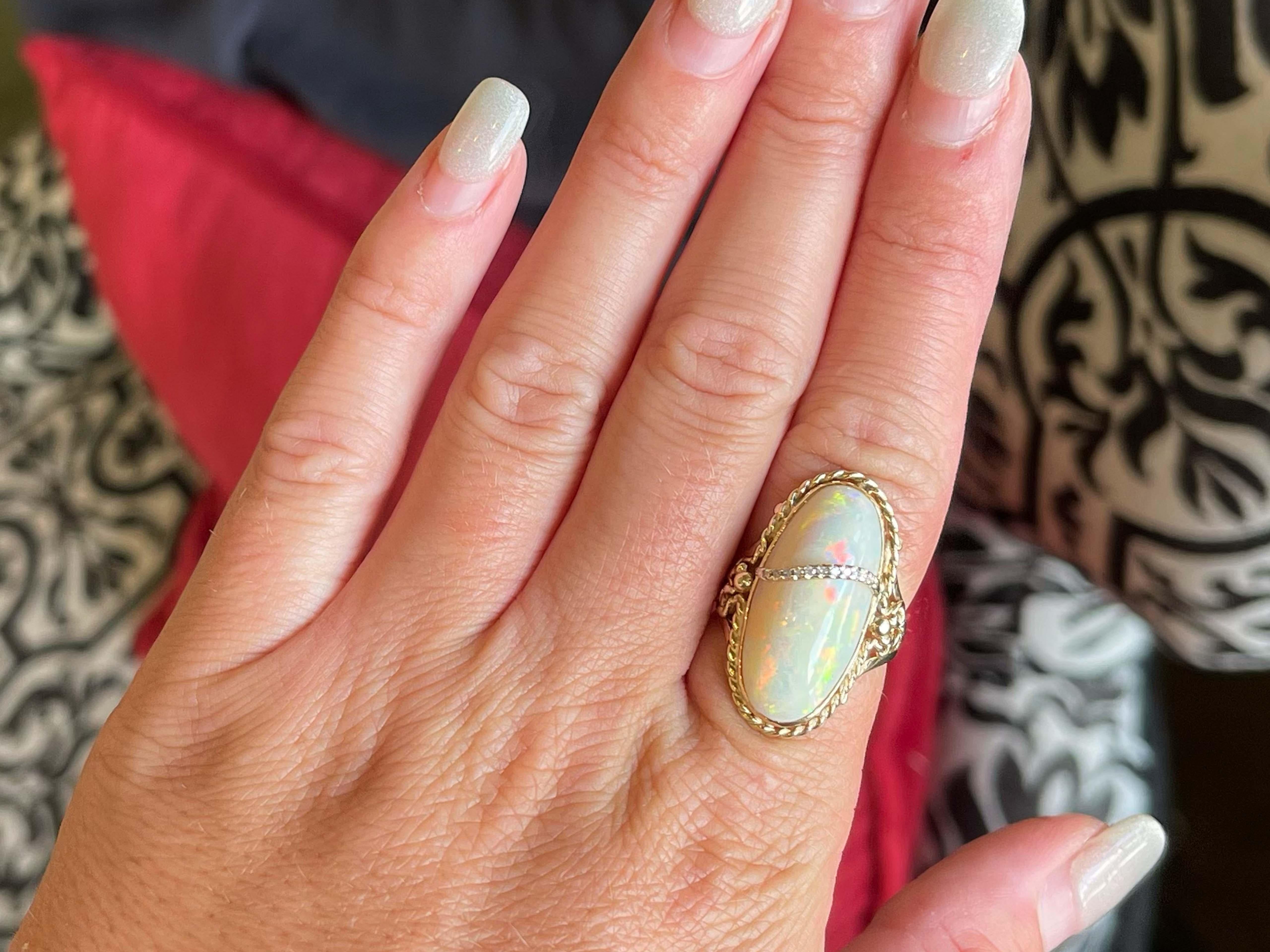 Item Specifications:

Metal: 14K Yellow Gold 

​​​Ring Size: 7

Total Weight: 6.1 Grams

Gemstone Specifications:

Center Gemstone: Opal

Gemstone Measurements: ~24.5 mm x 11.9 mm x 5.10 mm

Gemstone Carat Weight: ~8.4 carats

Diamond Count: