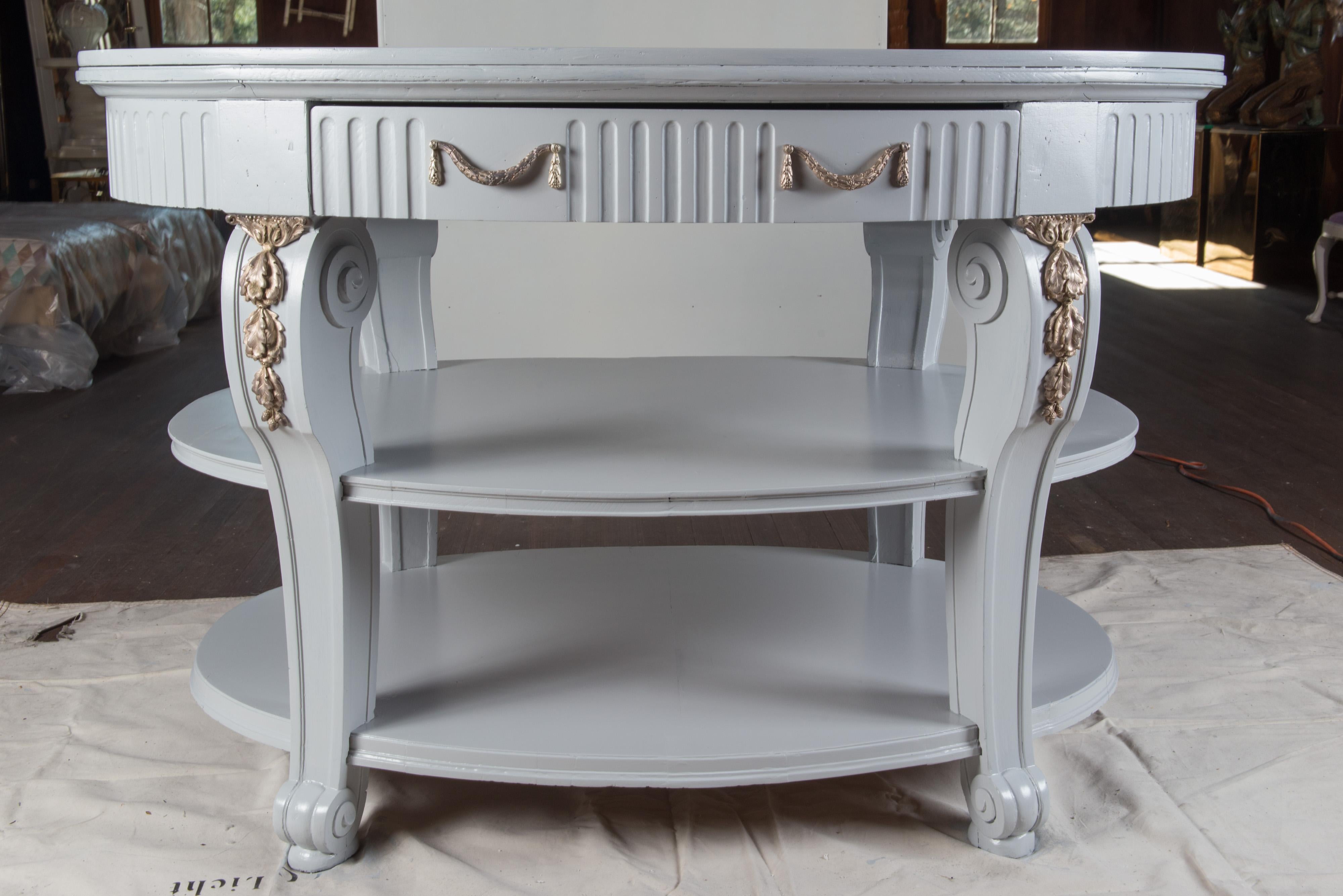 Grand light grey painted three-tiered oval center table with two large drawers. Original ormolu has been 
replated in a silver tone.