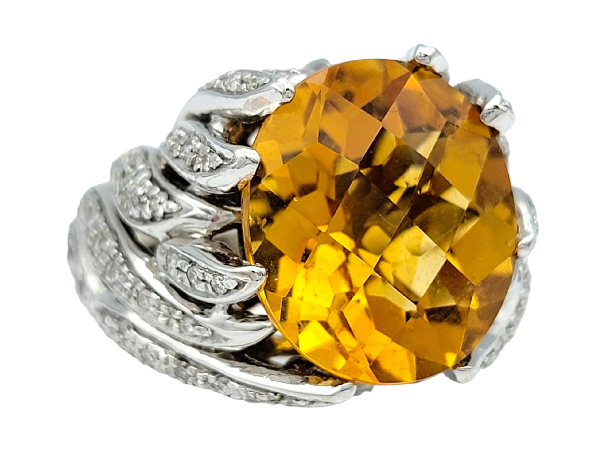 Ring Size: 8

This exquisite oval citrine and diamond cocktail ring is beautifully set in 14 karat white gold. The centerpiece of this stunning piece is a huge oval citrine, radiating a vibrant golden hue that captures attention. Surrounding the