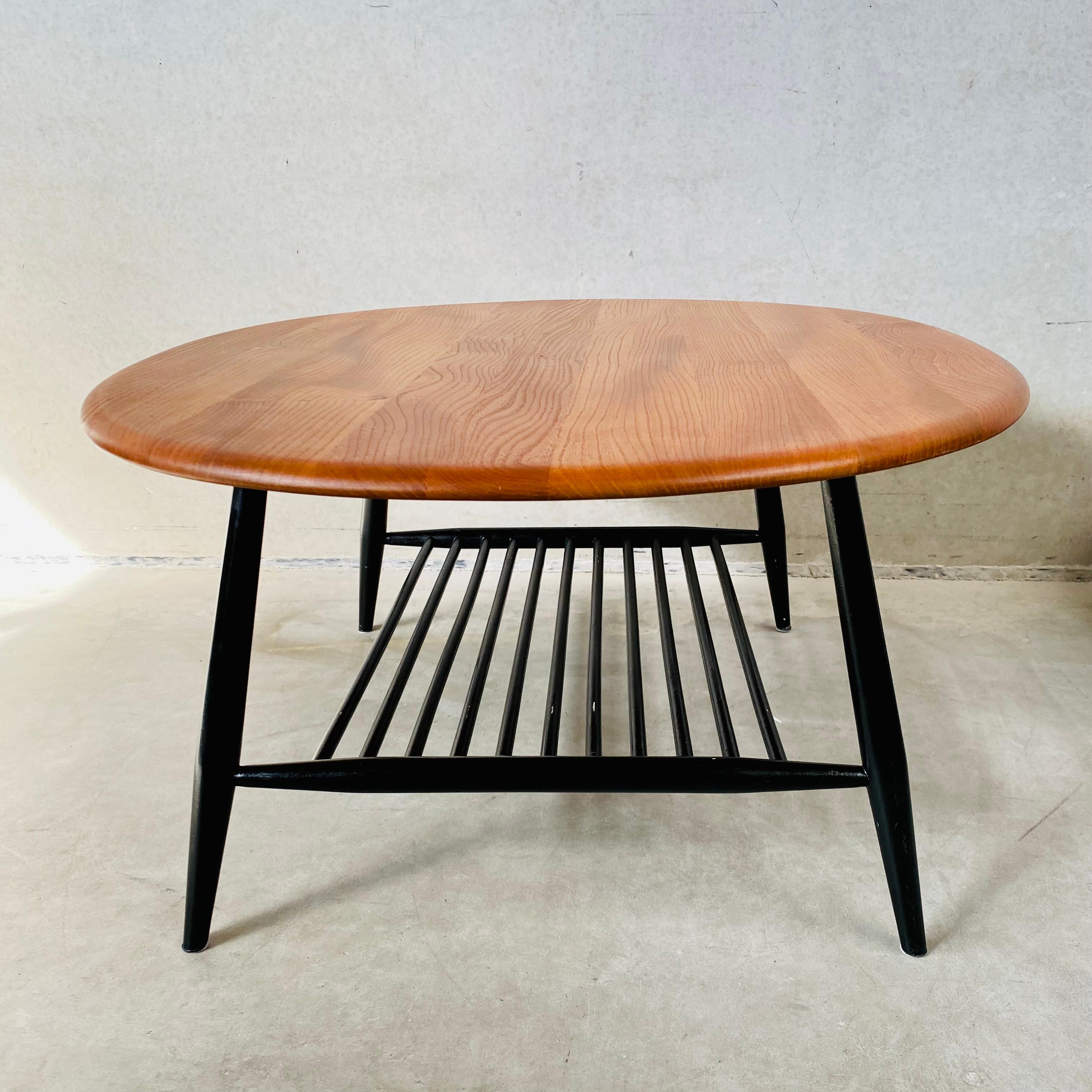 Voici l'exquise grande table basse ovale de Lucian Randolph Ercolani pour Ercol, Angleterre, dans les années 1950. Fabriquée avec une attention méticuleuse aux détails, cette table basse présente une étonnante base en hêtre massif laqué noir et un