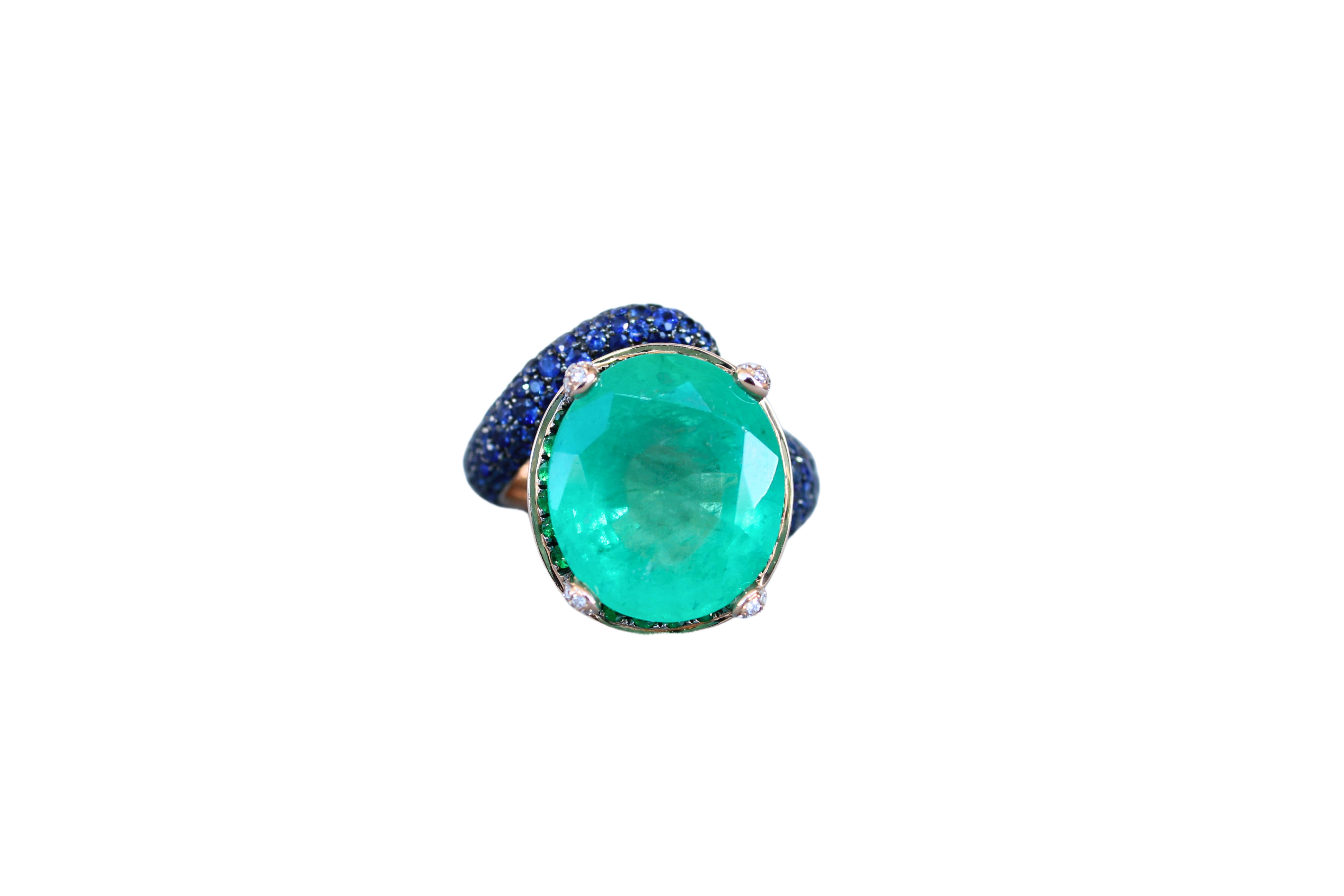 18K Yellow Gold 
14.28 grams
Inner size 5.75 - 6
14 Carats Oval-Shape Emerald
Untreated, Genuine & Natural
16.24 x 14.55 mm length width ratio of the Emerald
0.15 carats Diamonds G/VS Quality
2.5 Carats Blue Sapphires AAA Quality
3.0 Carats