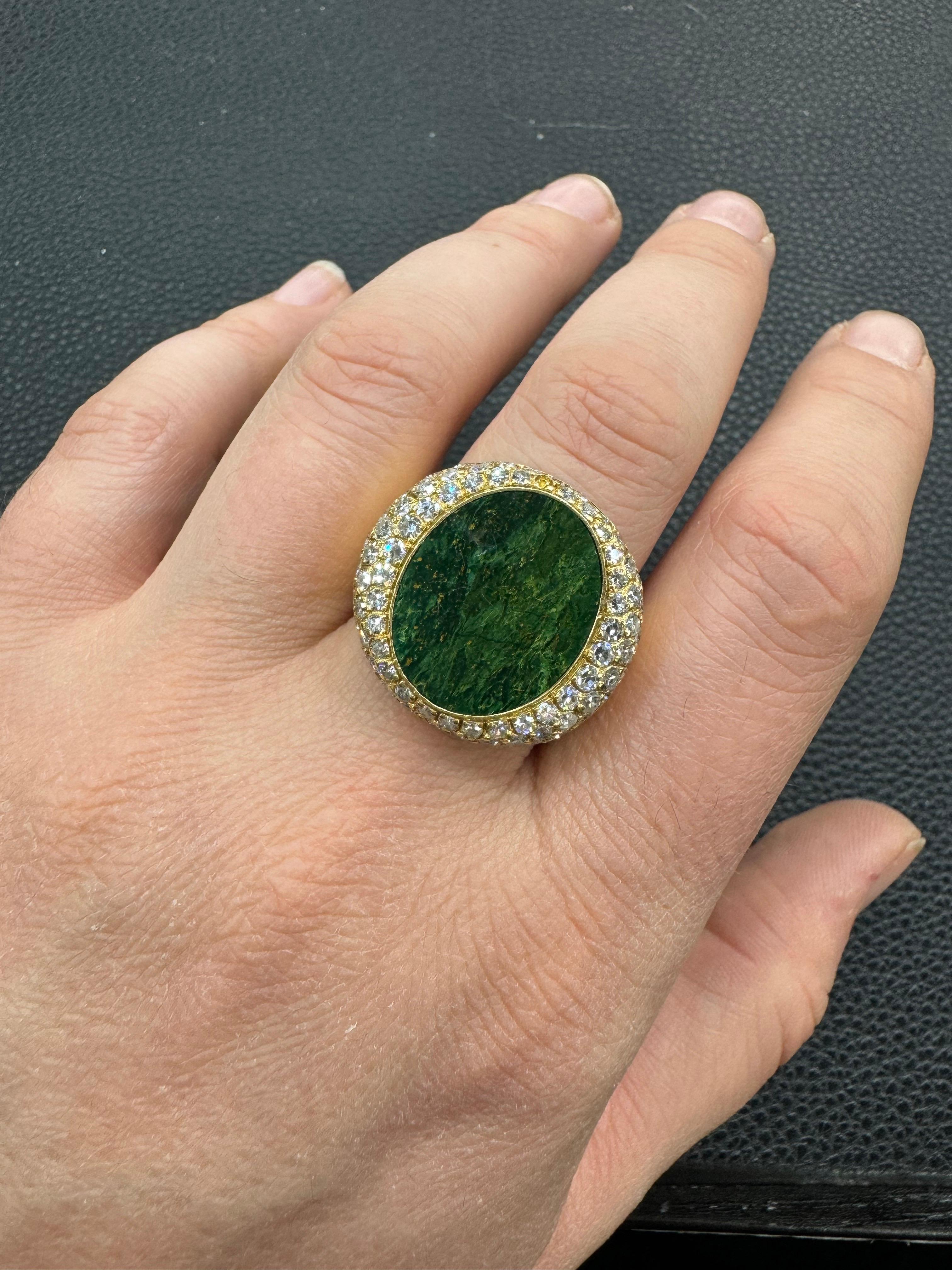 18 Karat yellow gold signet style ring featuring a Oval Cut Malachite flanked with round brilliants weighing approximately 1.50 carats. Ring measures 10.5 mm x 21.7 mm

More Malachite & Signet Rings Available.
Message for Prices & Information. 