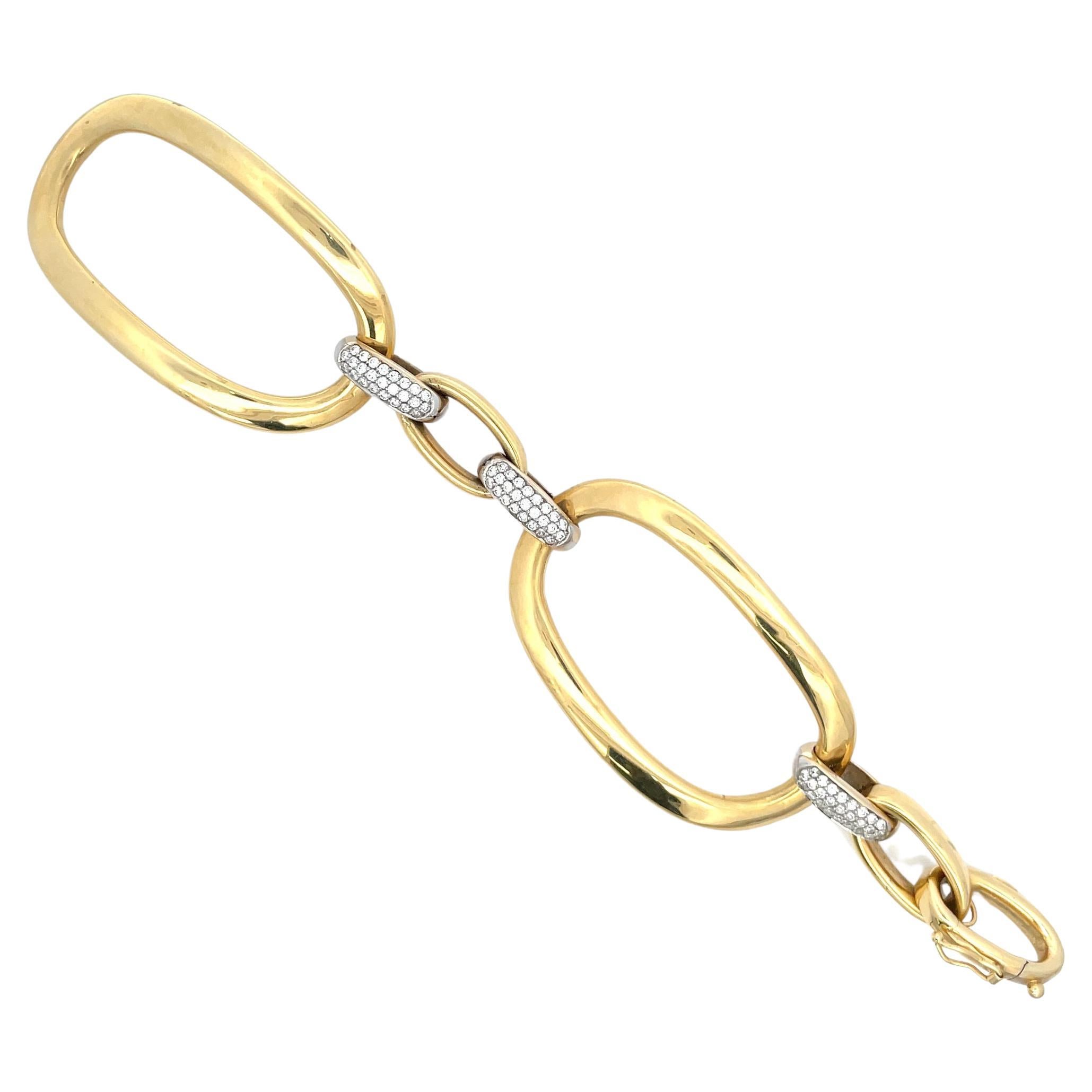 18 Karat Yellow Gold link bracelet featuring two large oval links with 75 diamond accents in between, weighing approximately 2 Carats. Will fit a short wrist.
Oval links 2.25 inches long x 1.30 inches wide