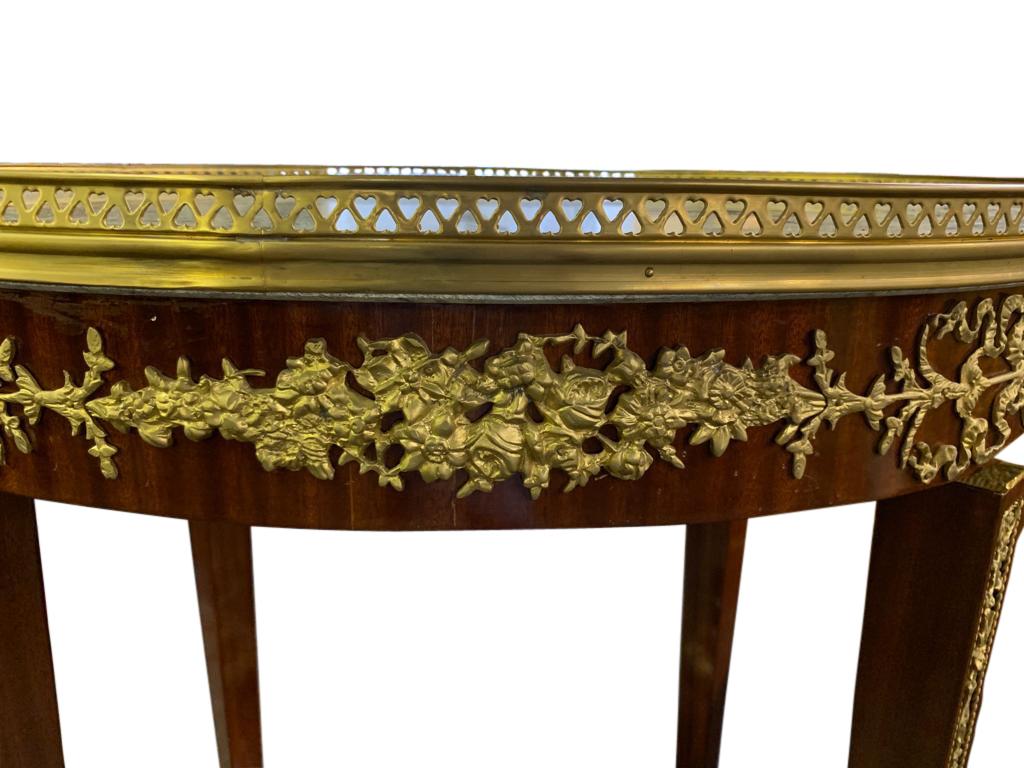 A gorgeous 20th century French Empire style side tables with marble tops - smooth and chip free. Ormolu fixtures bright, well cast and original. Offered in excellent shape.