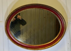 Large Oval Gilt and Red Wall Mirror  This Mirror has a 3" wide moulded oval fram