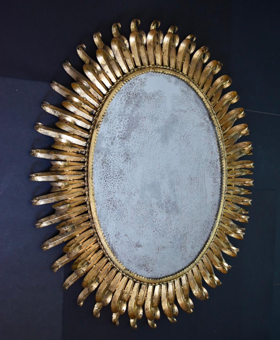 Italian Large Oval Gilt Iron Sunburst Soleil Wall Mirror For Sale