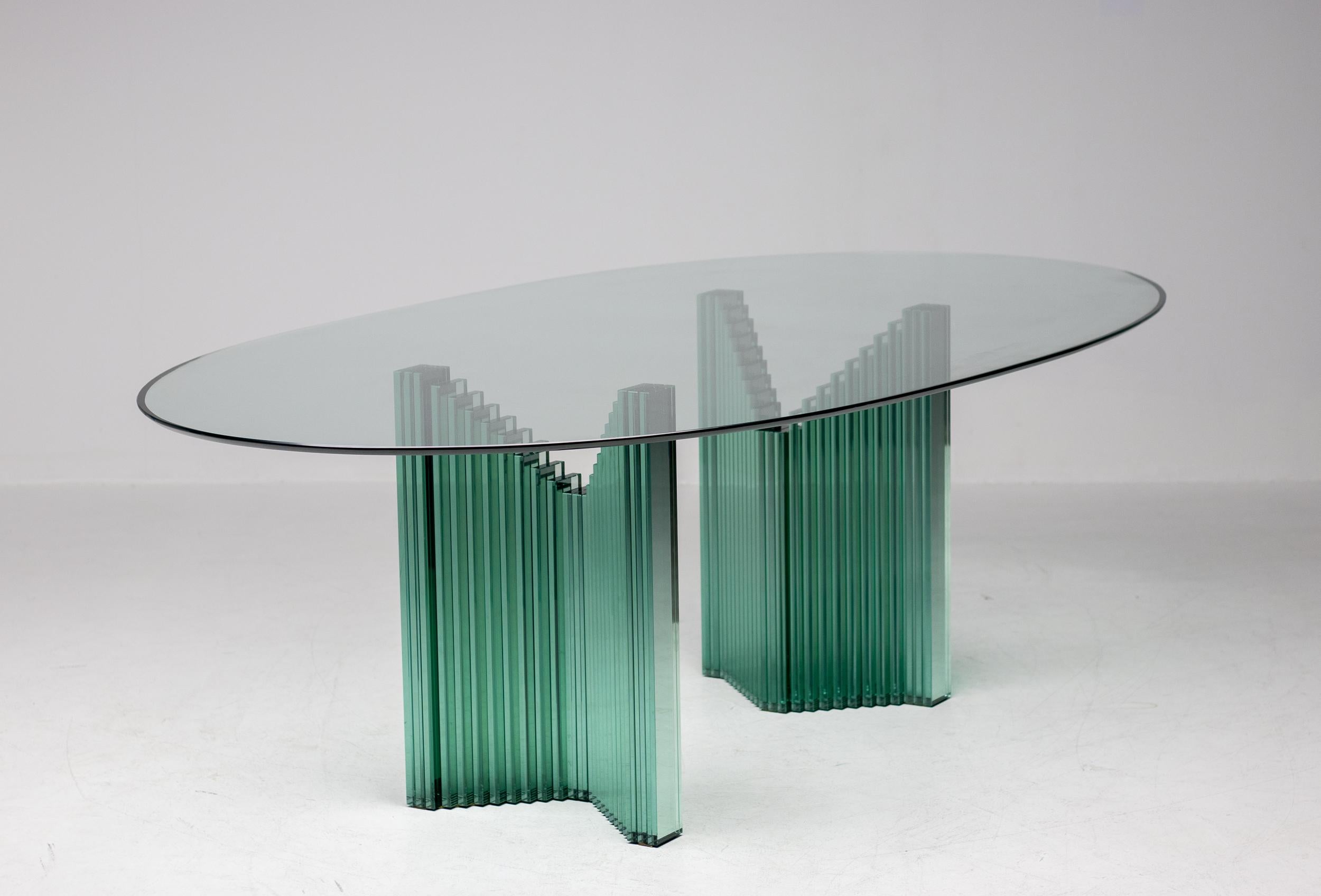 Versatile oval all glass table designed circa 1980 by Luigi Massoni for Gallotti & Radice.
Useable as a desk or a conference table depending on how the 2 glass bases are placed underneath the top. Placed inside out it is a very impressive large